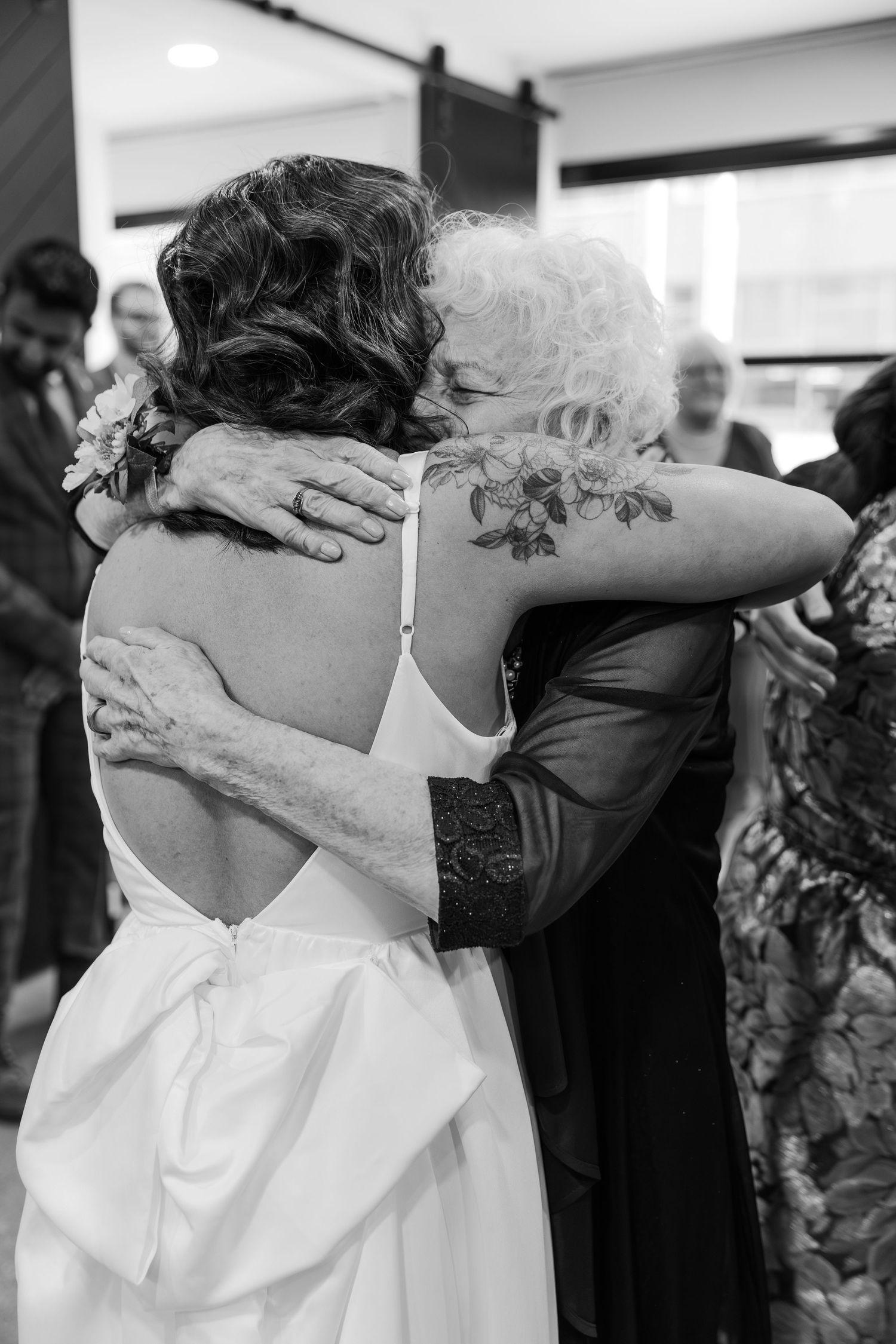 Bride shares a tight embrace with grooms grandmother after the ceremony at the DTK chapel in downtown Kitchener, Ontario.