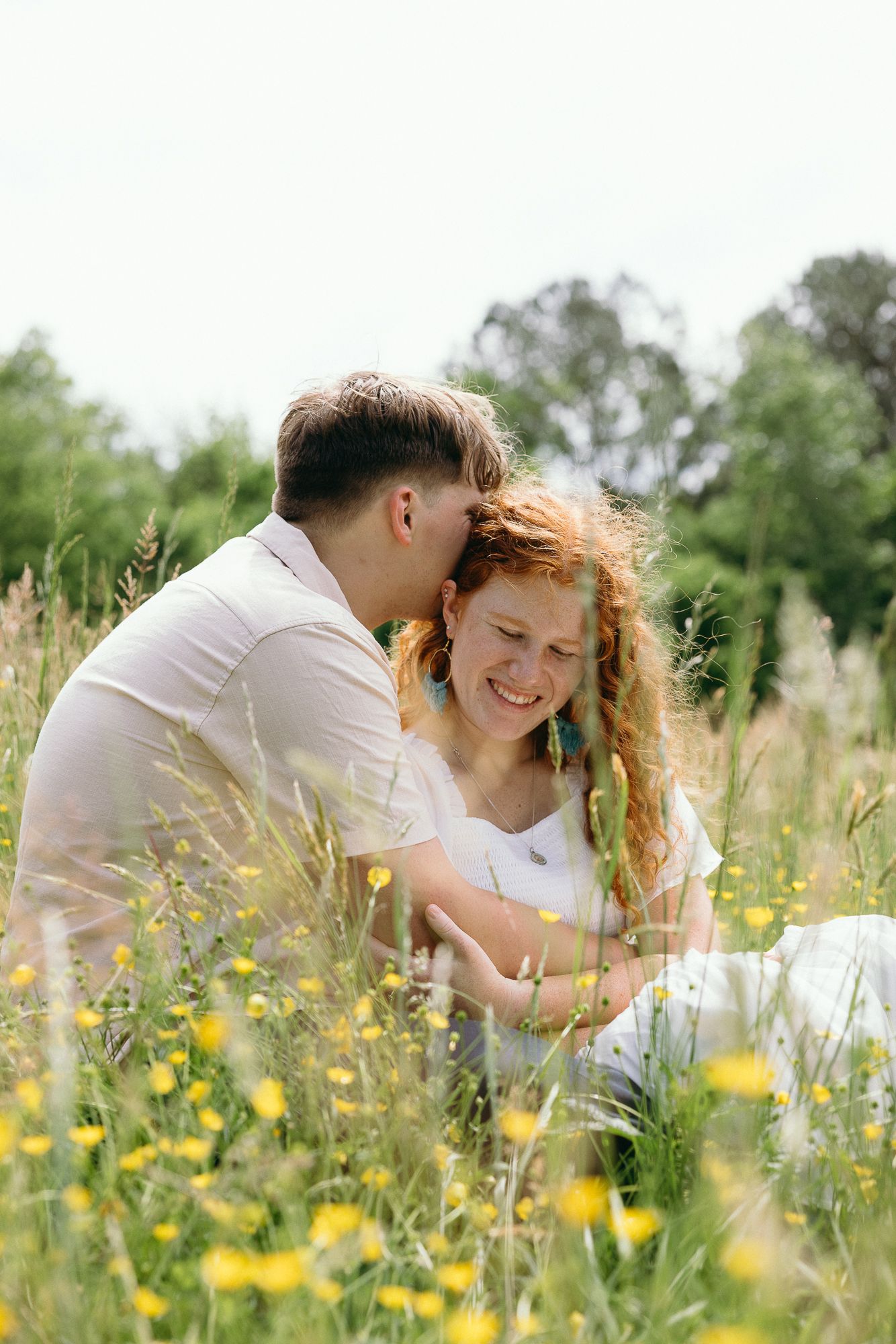 A joyful moment captured in a sunny wildflower meadow with yellow blooms. The Bradford, Separk  Mansion, Graylyn Estate