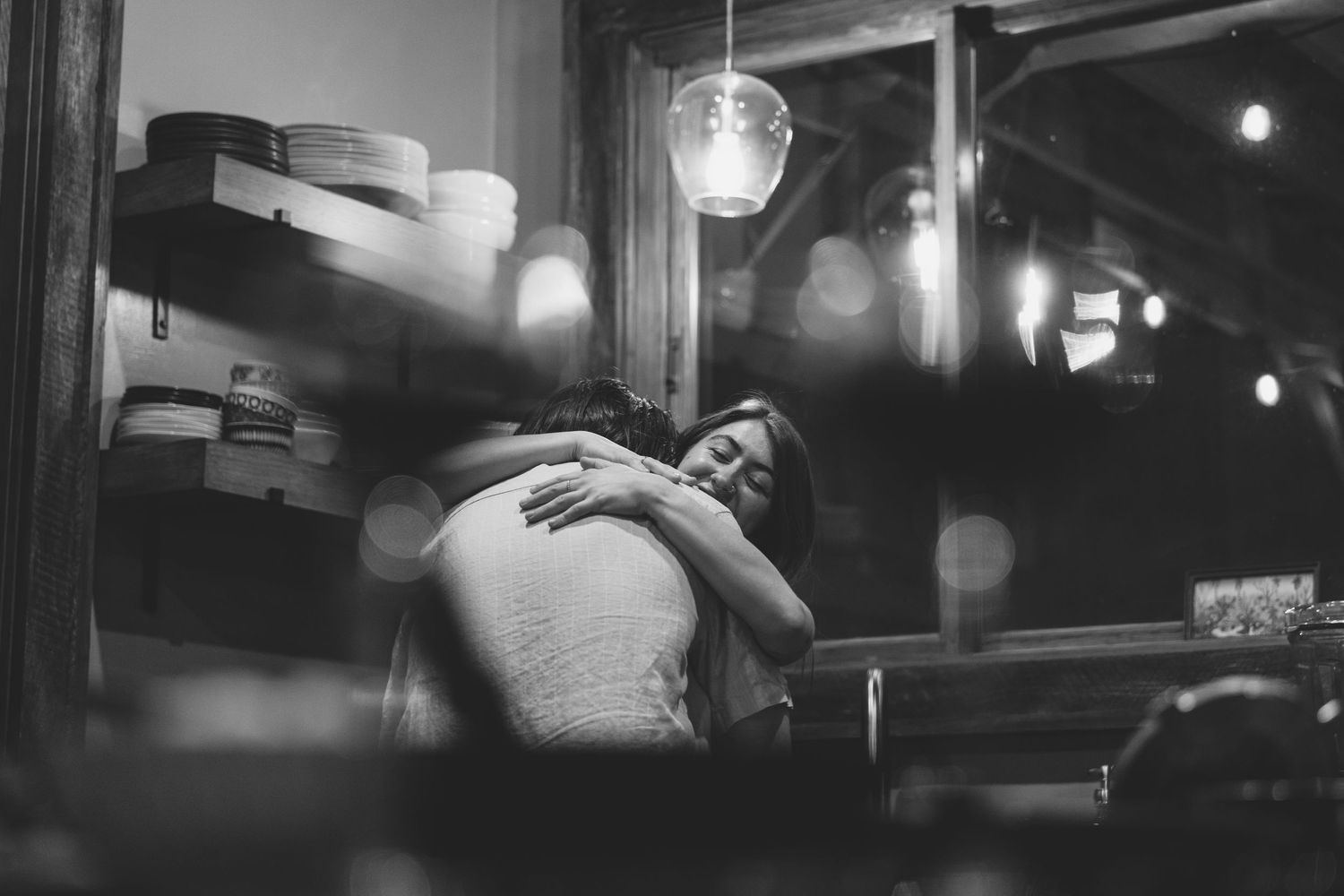 A moody black and white urban nighttime scene with bokeh lights. Separk Mansion Wedding Photographer