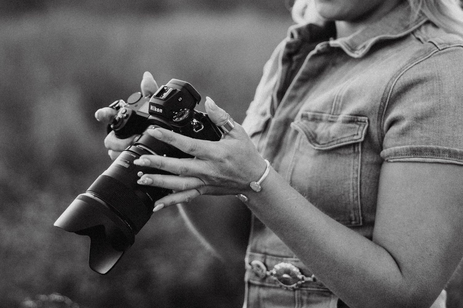 Photographer posing with camera, showcasing their passion for capturing memorable moments and stunning images.