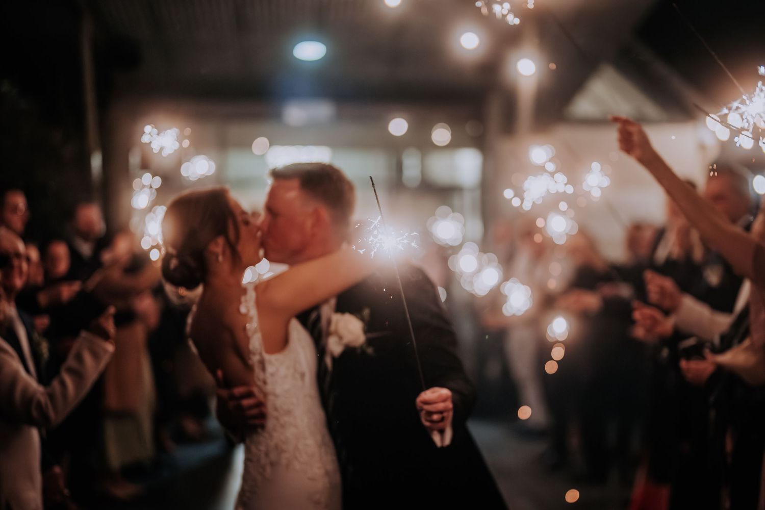 Wedding celebration with sparklers creating a magical nighttime atmosphere.