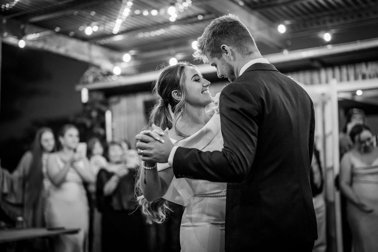 Wedding reception dance sequence under warm indoor lighting.