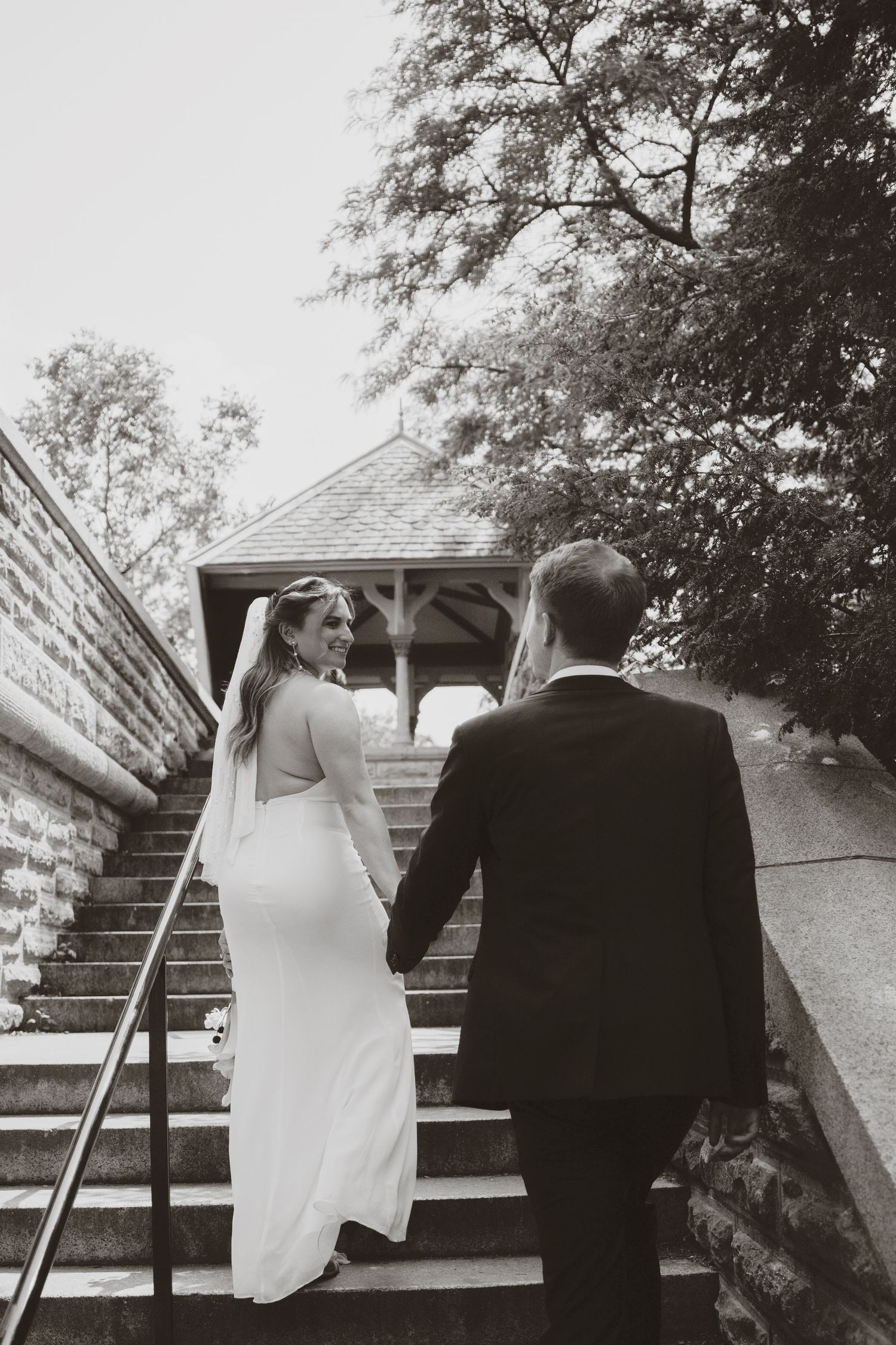 A romantic black and white photo series shows a couple sitting together on outdoor steps at different angles.