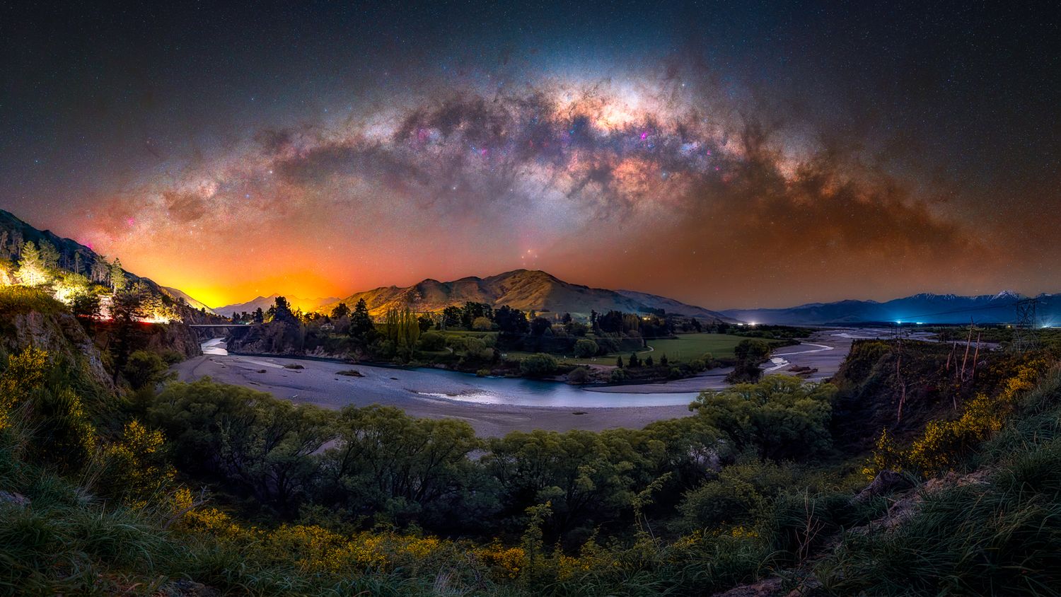 Night sky panorama featuring the Milky Way galaxy over dark landscape.