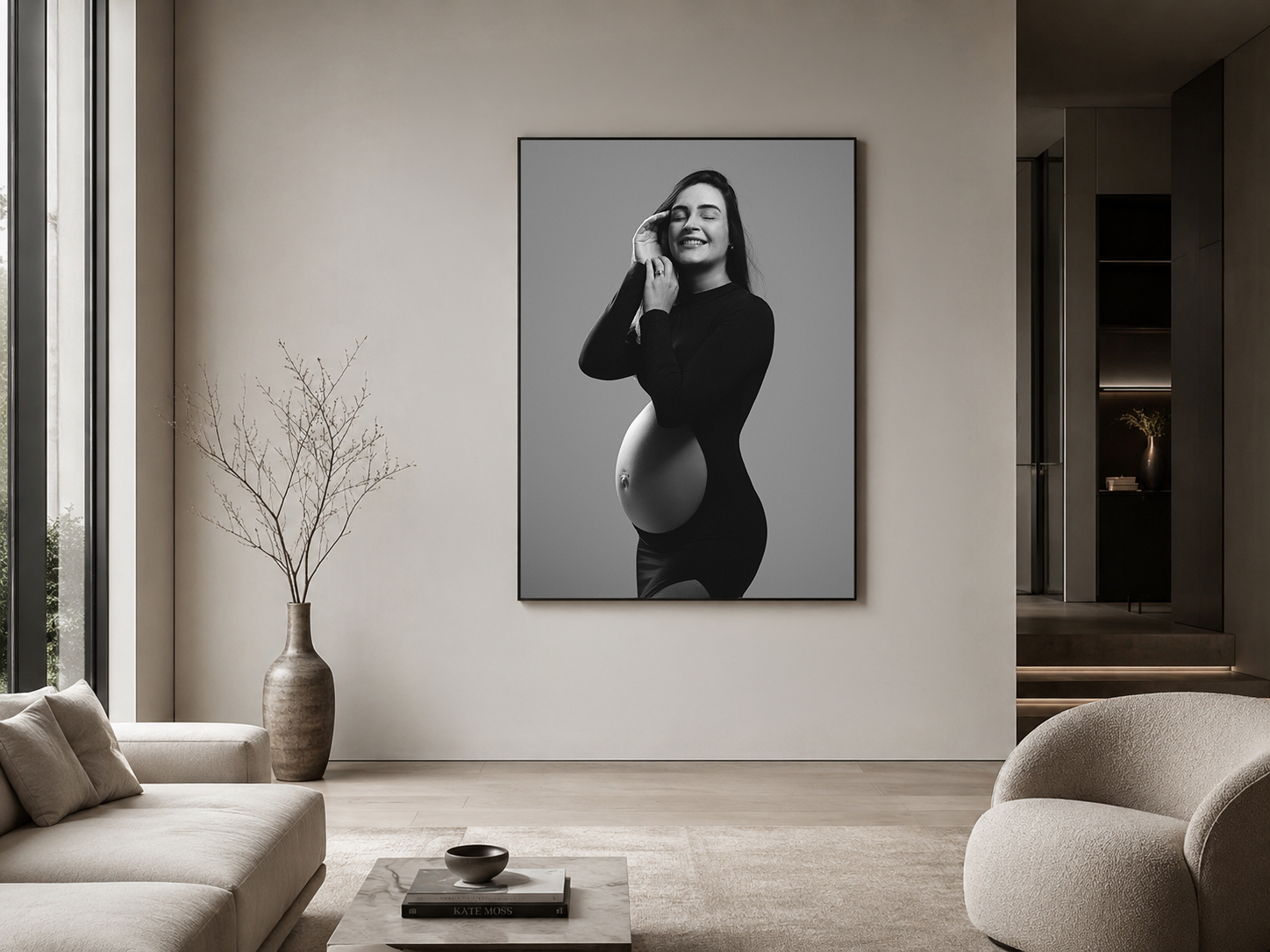 Black and white maternity photo print displayed in a modern minimalist living room with neutral tones.