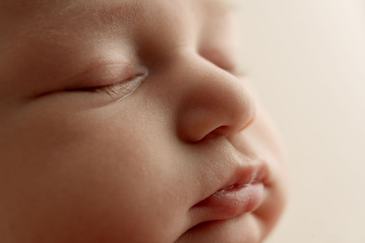 Close-up macro photograph showing soft features of a sleeping baby's nose and lips. – newborn photographer Paloma Schell Houston TX