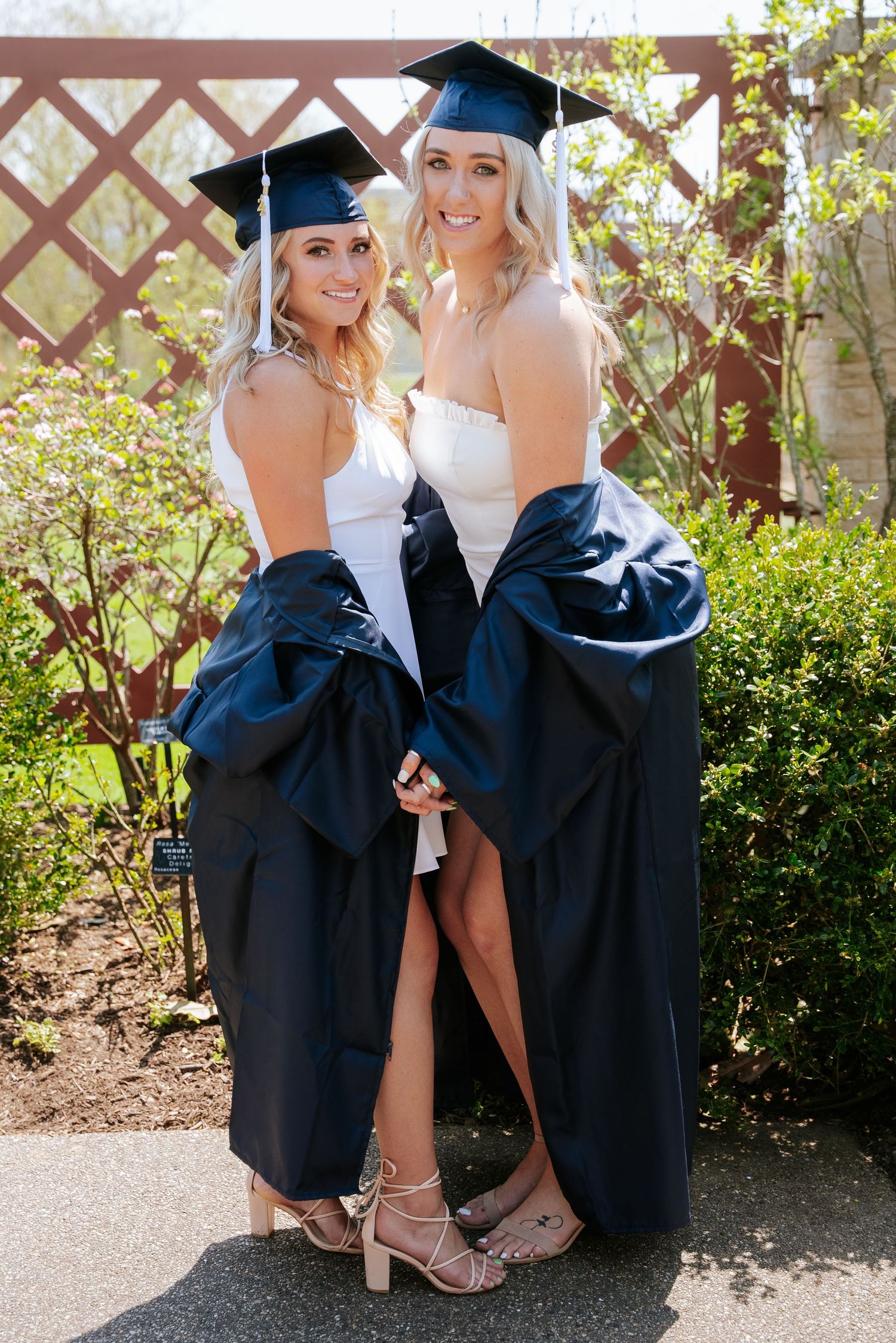 College graduates in cap and gown during a graduation photo session.