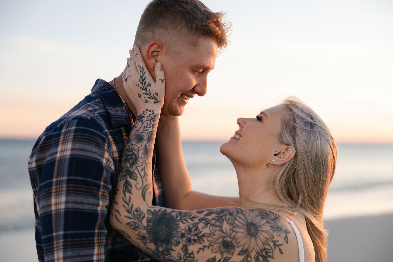 wife looking into her husbands eyes while holding the side of his face