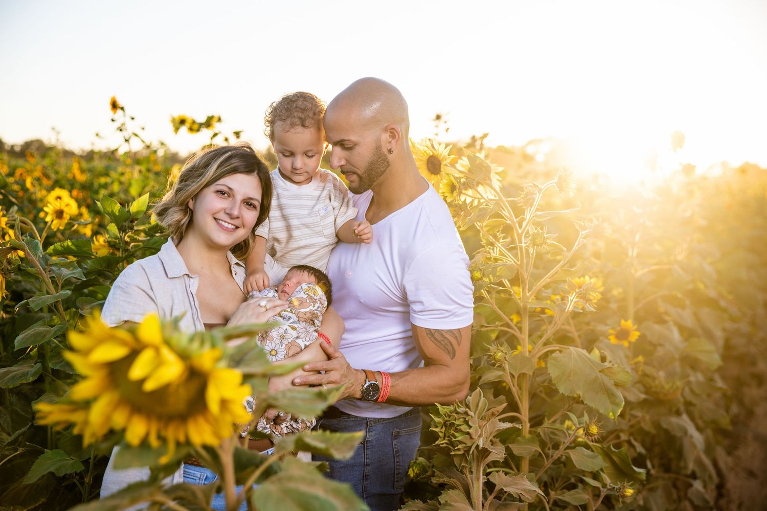 family being photographed in a sunflower field