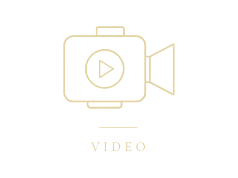 Gold outline video camera icon with play button symbol above the word VIDEO on white background.