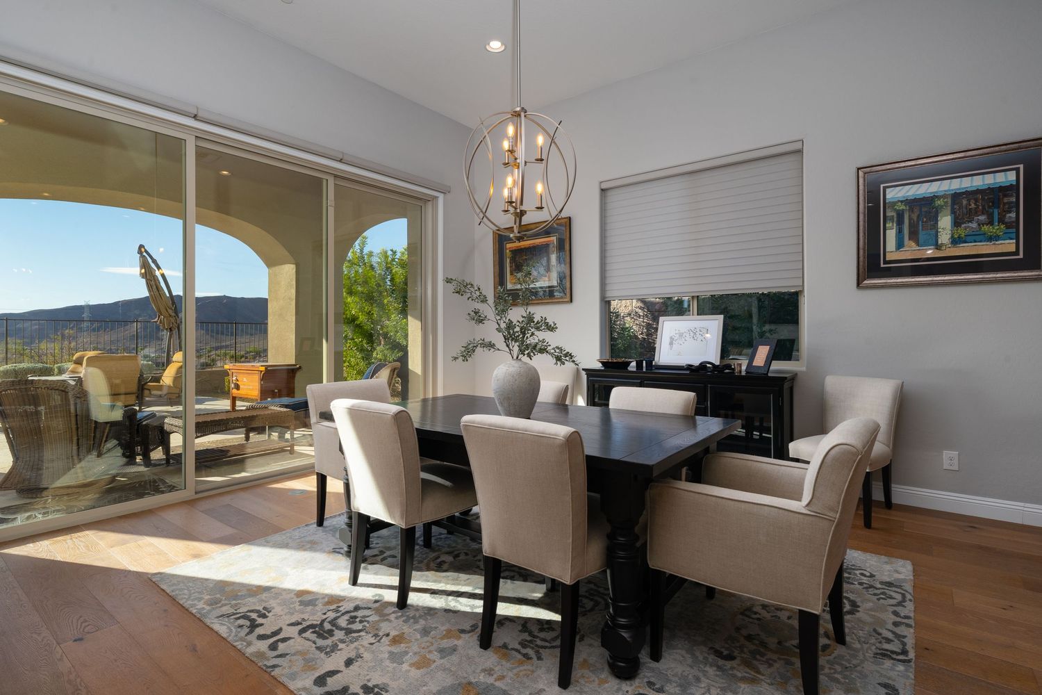 Open concept living space with panoramic windows offering mountain views and contemporary furnishings.