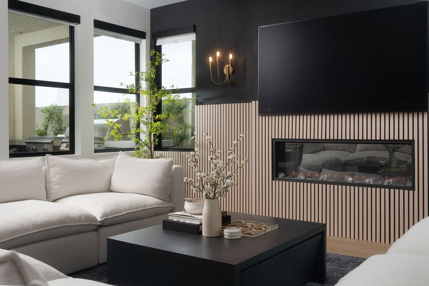 Minimalist black and white living space with modern furniture and ambient lighting.