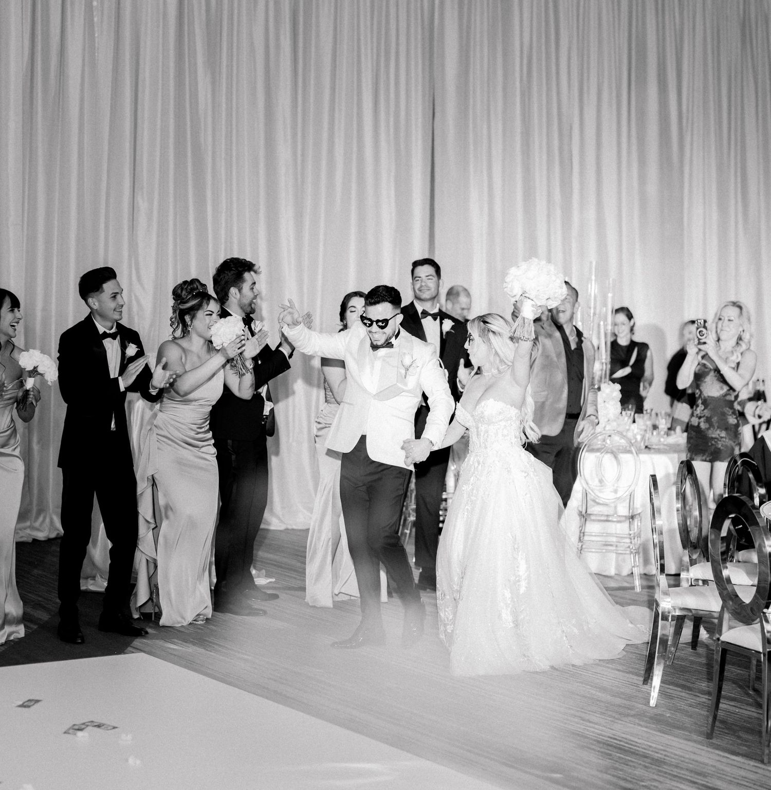 A joyous celebration on the dance floor at a black and white wedding reception at The Omni Hotel in Louisville, Kentucky. White roses.