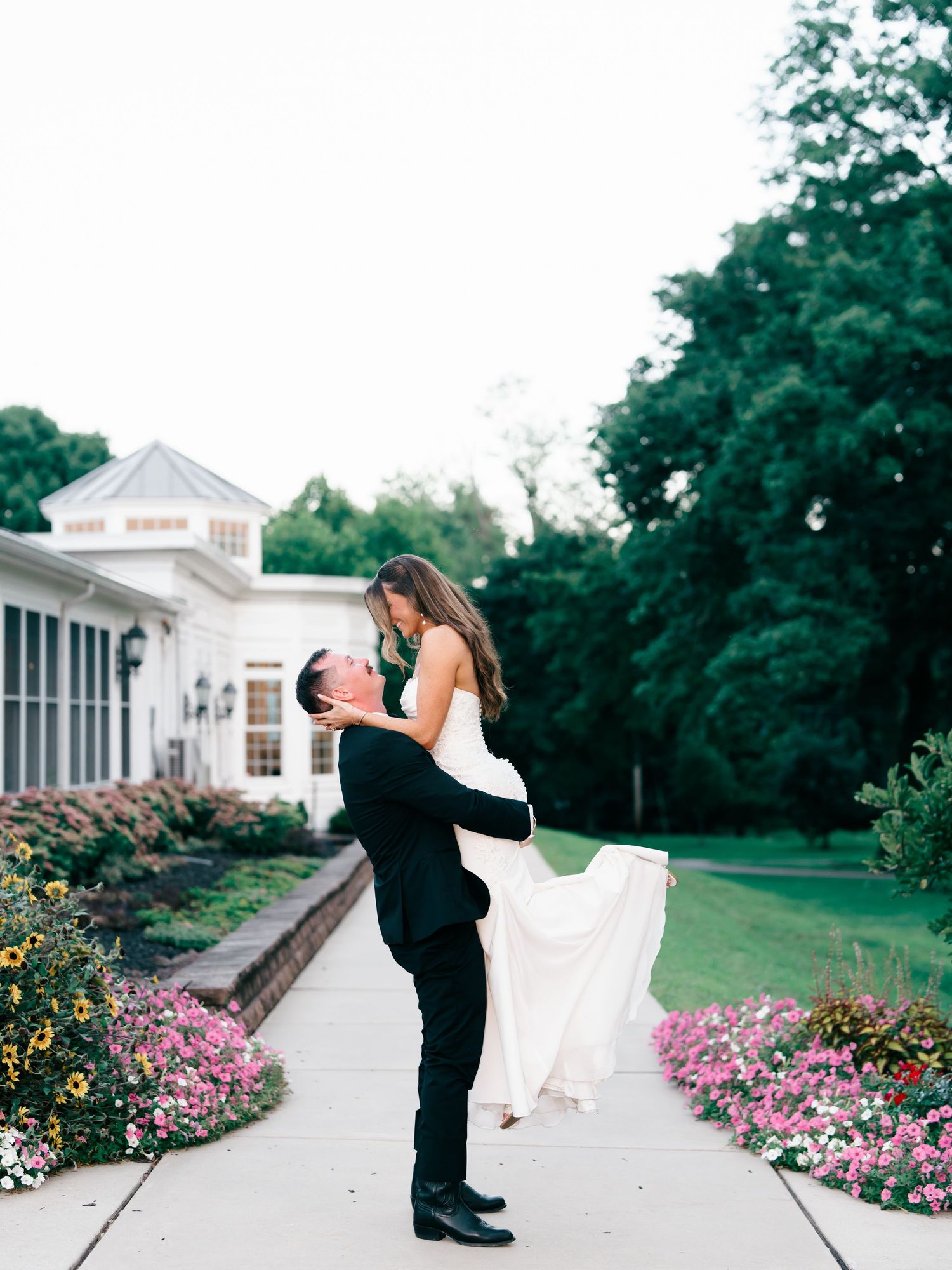 Bride and Groom at The Cameron Inn Estate in Mount Joy, Pennsylvania. The groom is picking up the bride & celebrating just getting married.