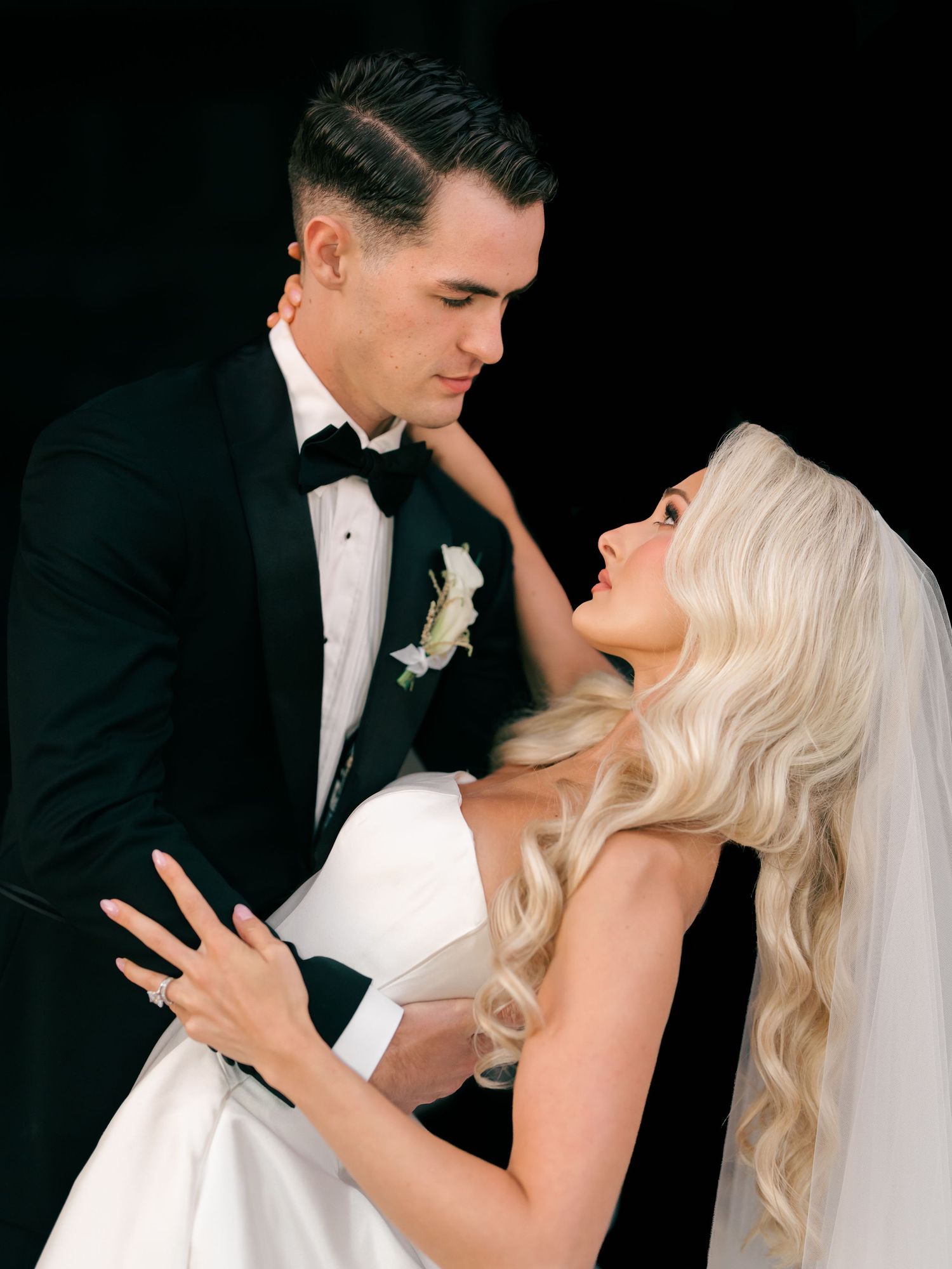 Groom in a black tux dances closely with a bride in a white gown with long wavy blonde hair & veil. At The Brown Hotel Louisville, Kentucky.