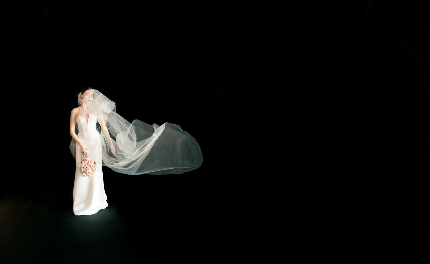 Elegant bride figurine in white gown with flowing veil against dark background, perfect wedding cake topper.