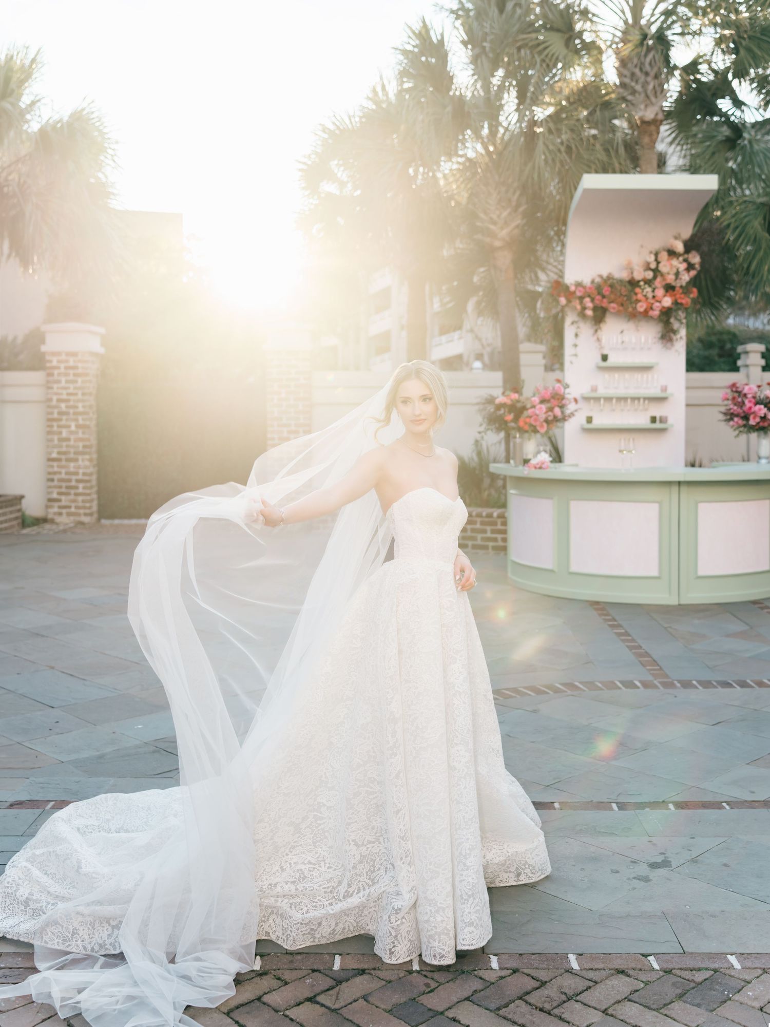 Ethereal bridal portrait series with flowing veil and lace gown captured in golden sunlight at dusk.