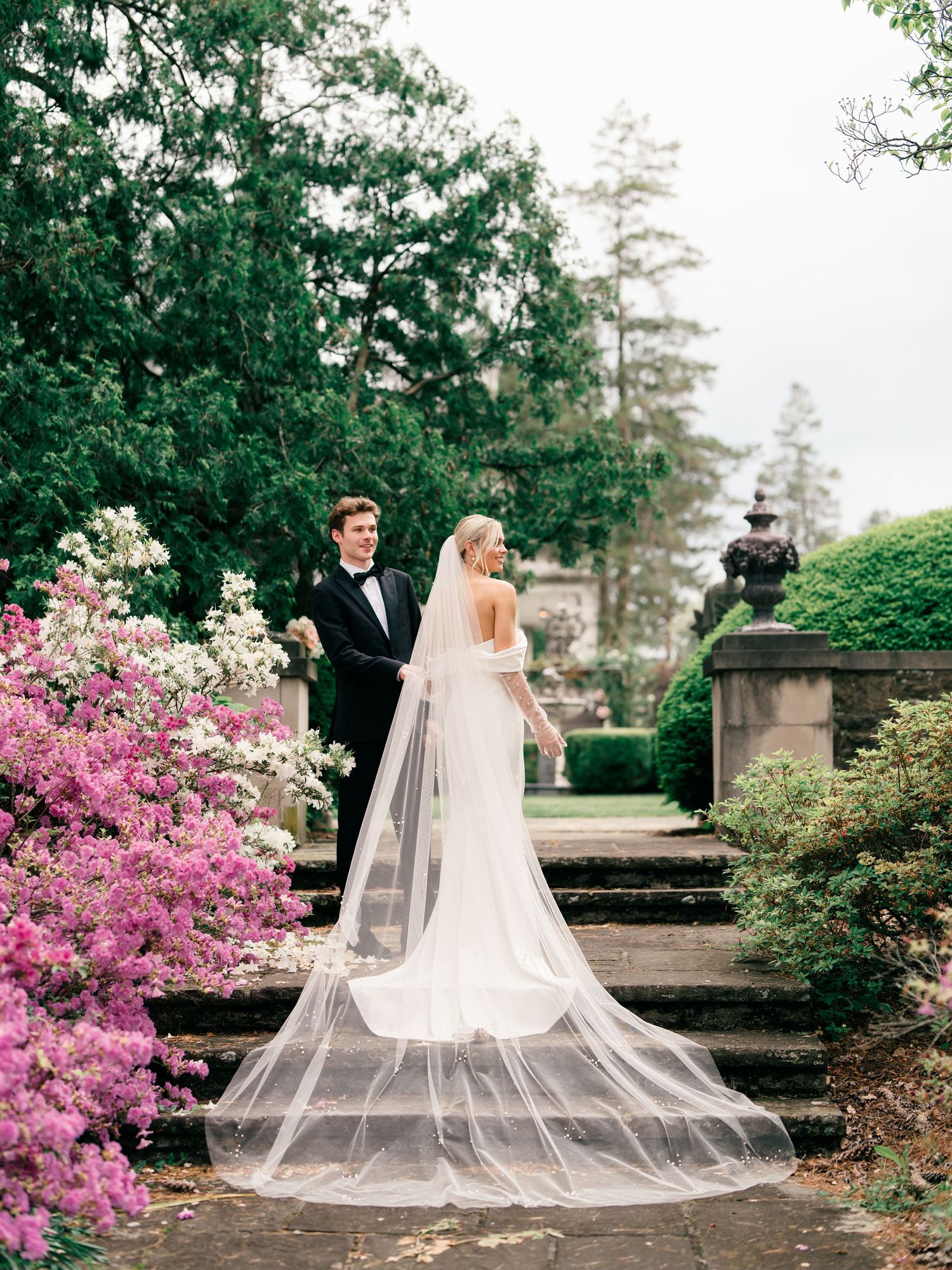A series of wedding photos showing a flowing veil against lush garden greenery and pink azalea blooms in spring.