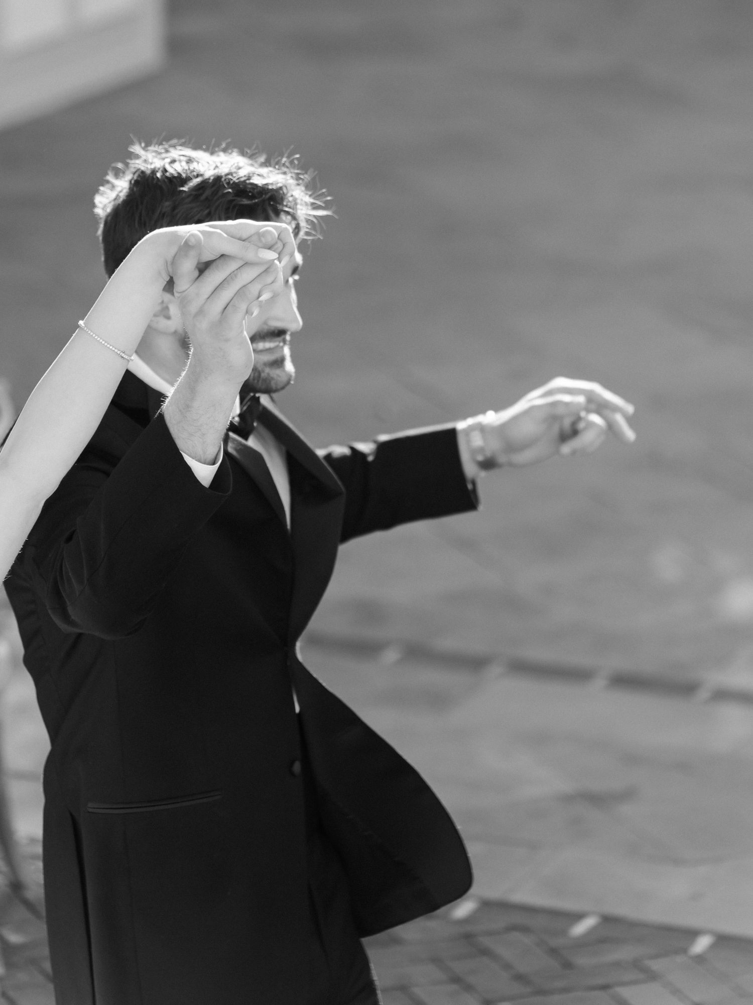 Black and white artistic photo showing silhouettes with dramatic gestures.