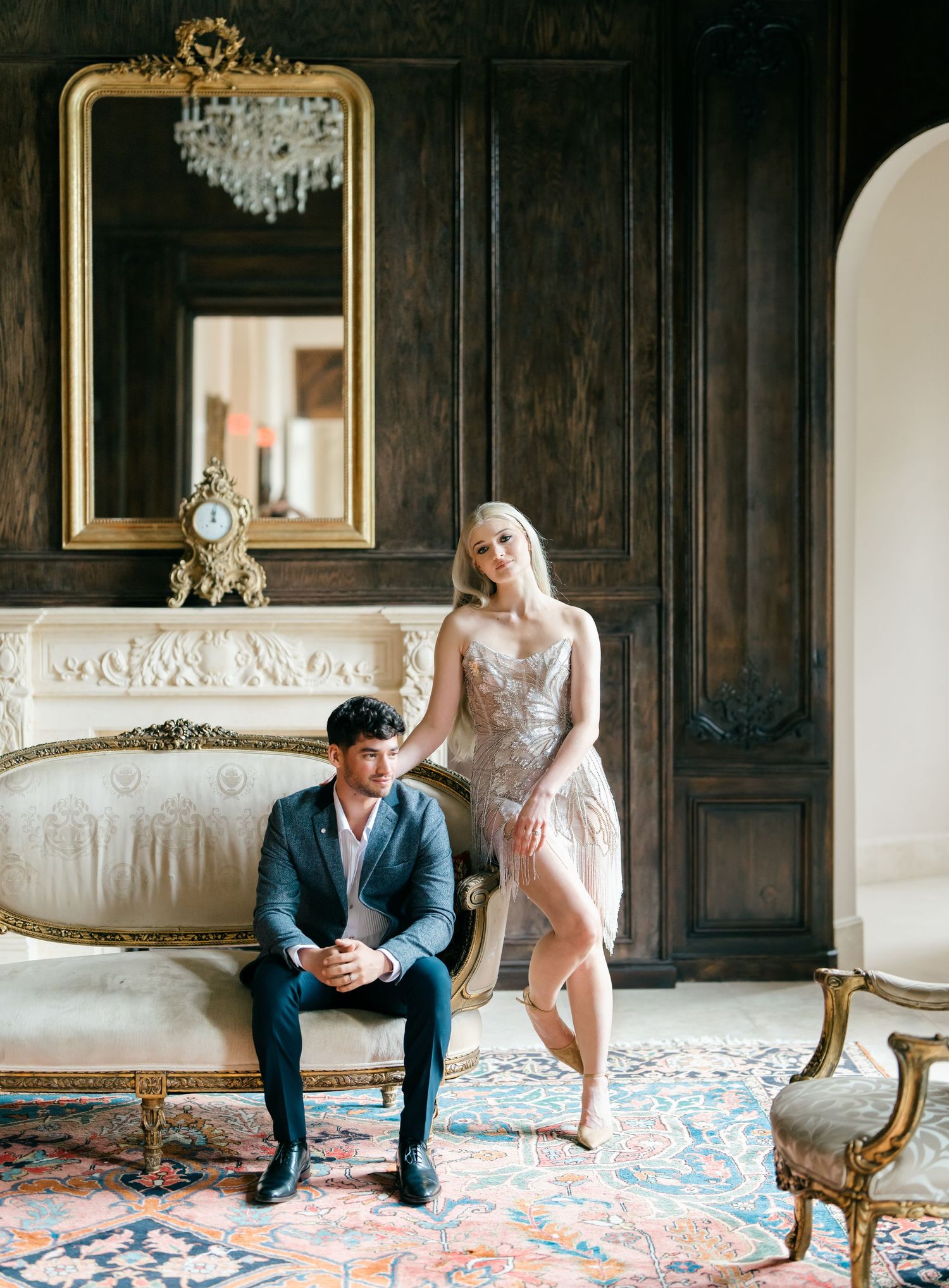 Wedding photography session in a luxurious dark wood-paneled room with antique furniture and patterned carpet.