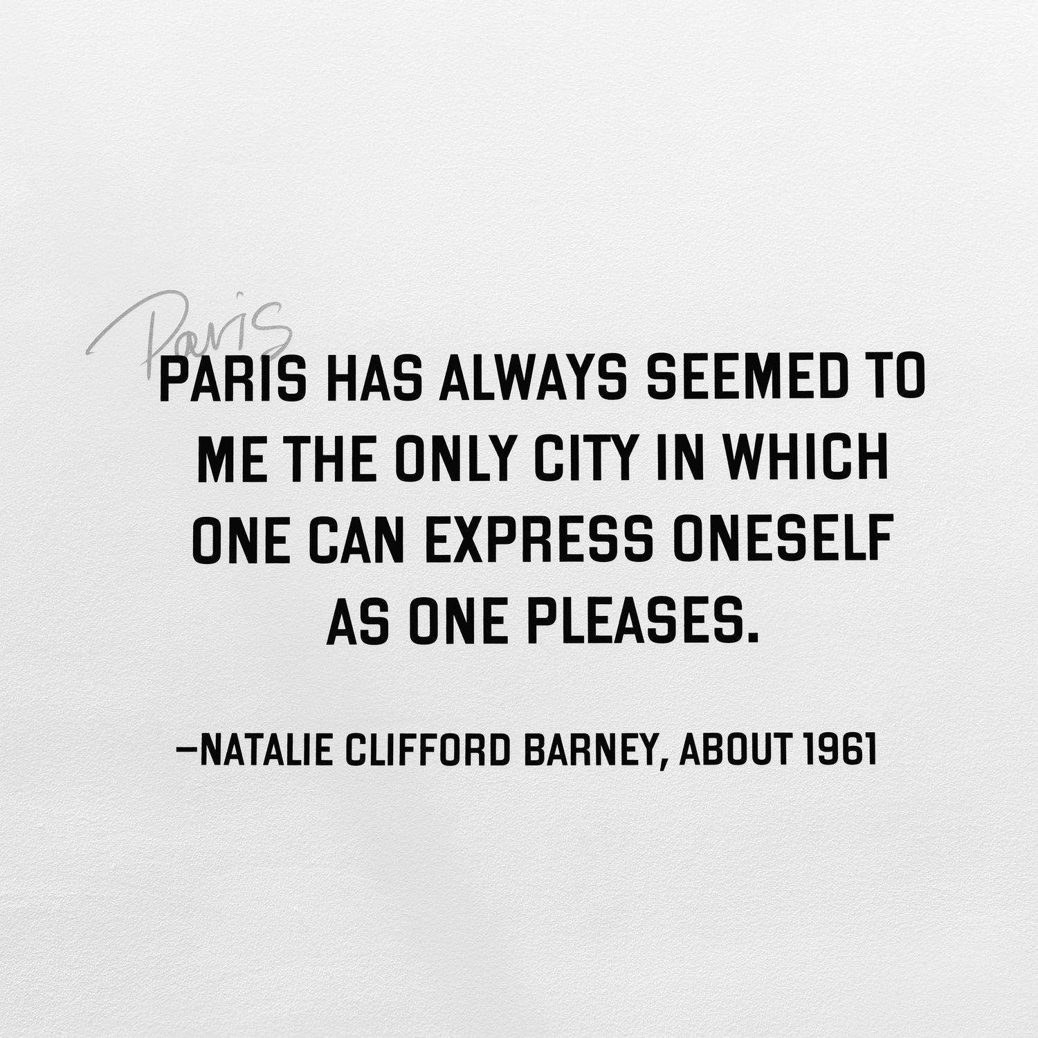 A black and white quote about Paris being a city of self-expression, attributed to Natalie Clifford Barney from 1961.