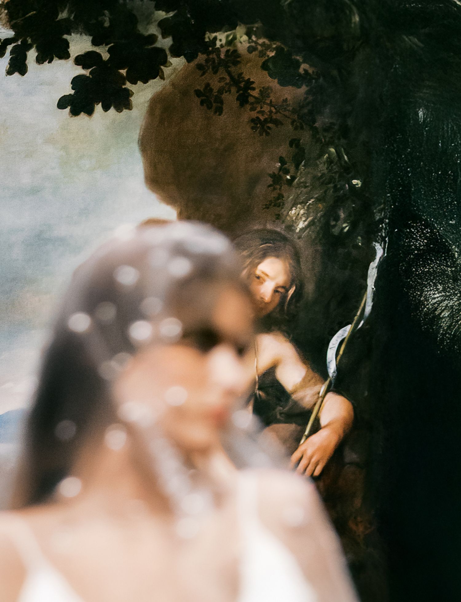 Artistic wedding photo with dreamy bokeh lighting and tree foliage creating shadowy silhouettes at The Cincinnati Art Museum.