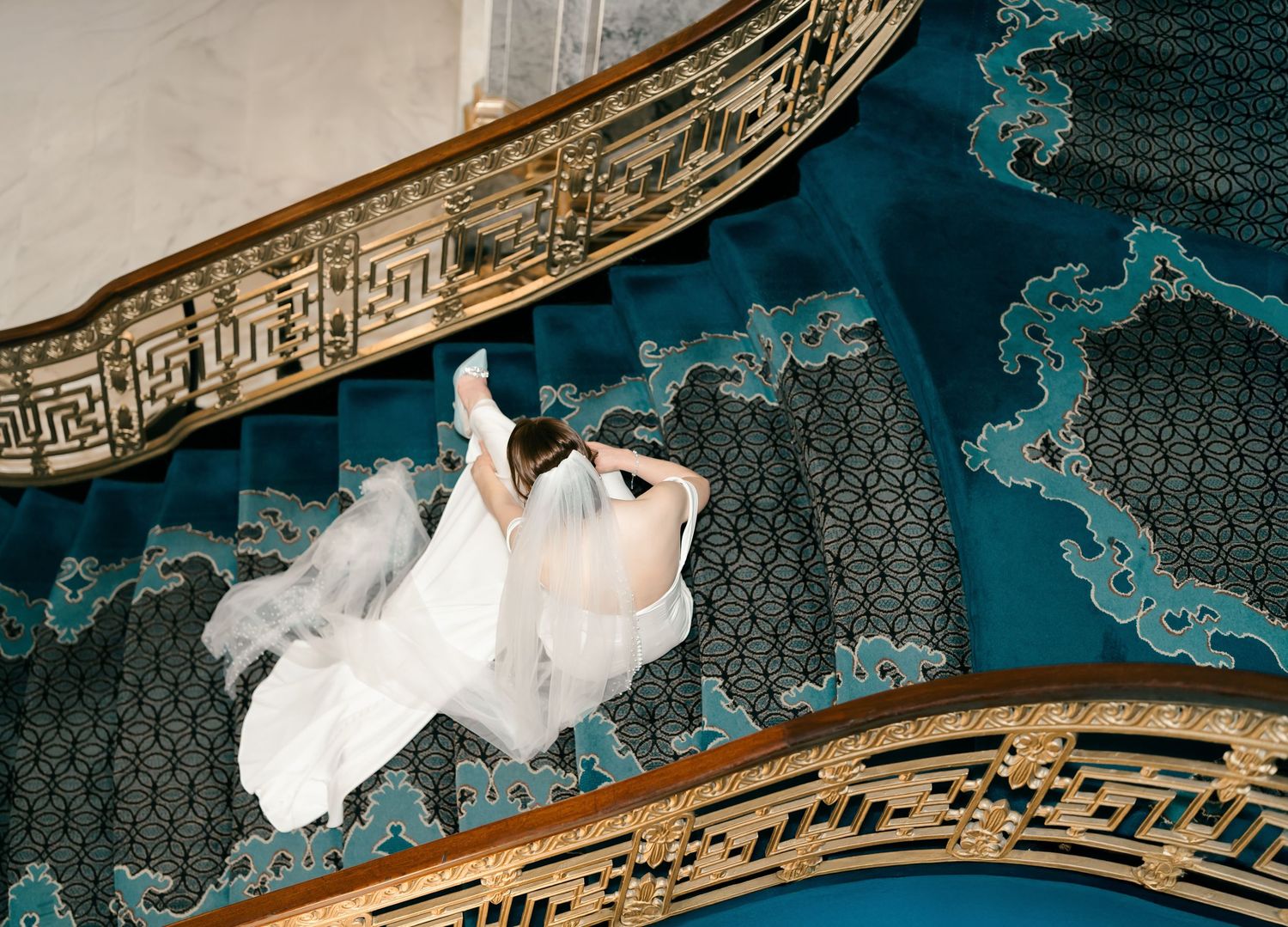 Ornate classic Chinese style architectural details featuring gold trim and decorative patterns against a dark teal background.
