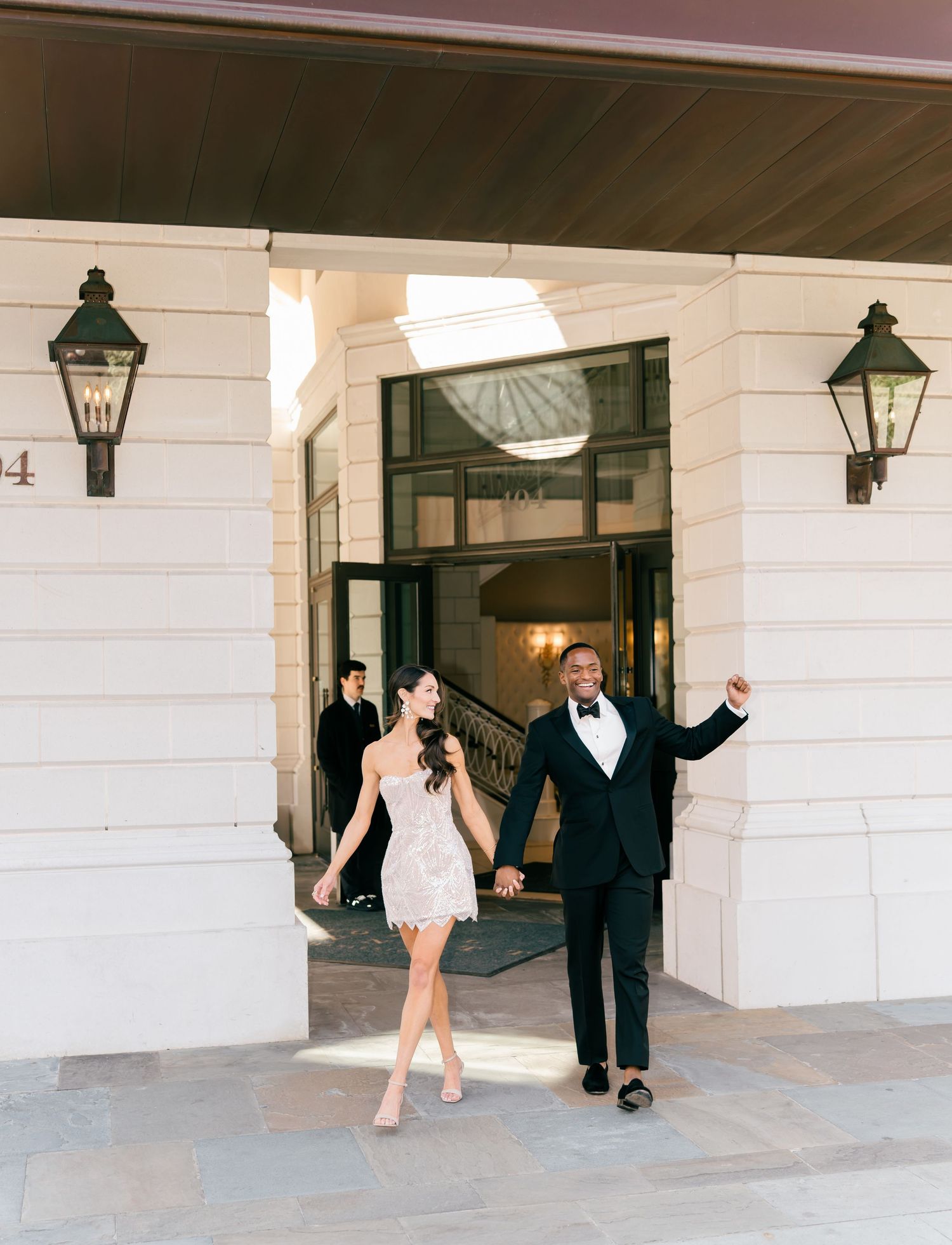 A series of wedding party photos showing playful poses and interactions in a white columned hallway with vintage lanterns.
