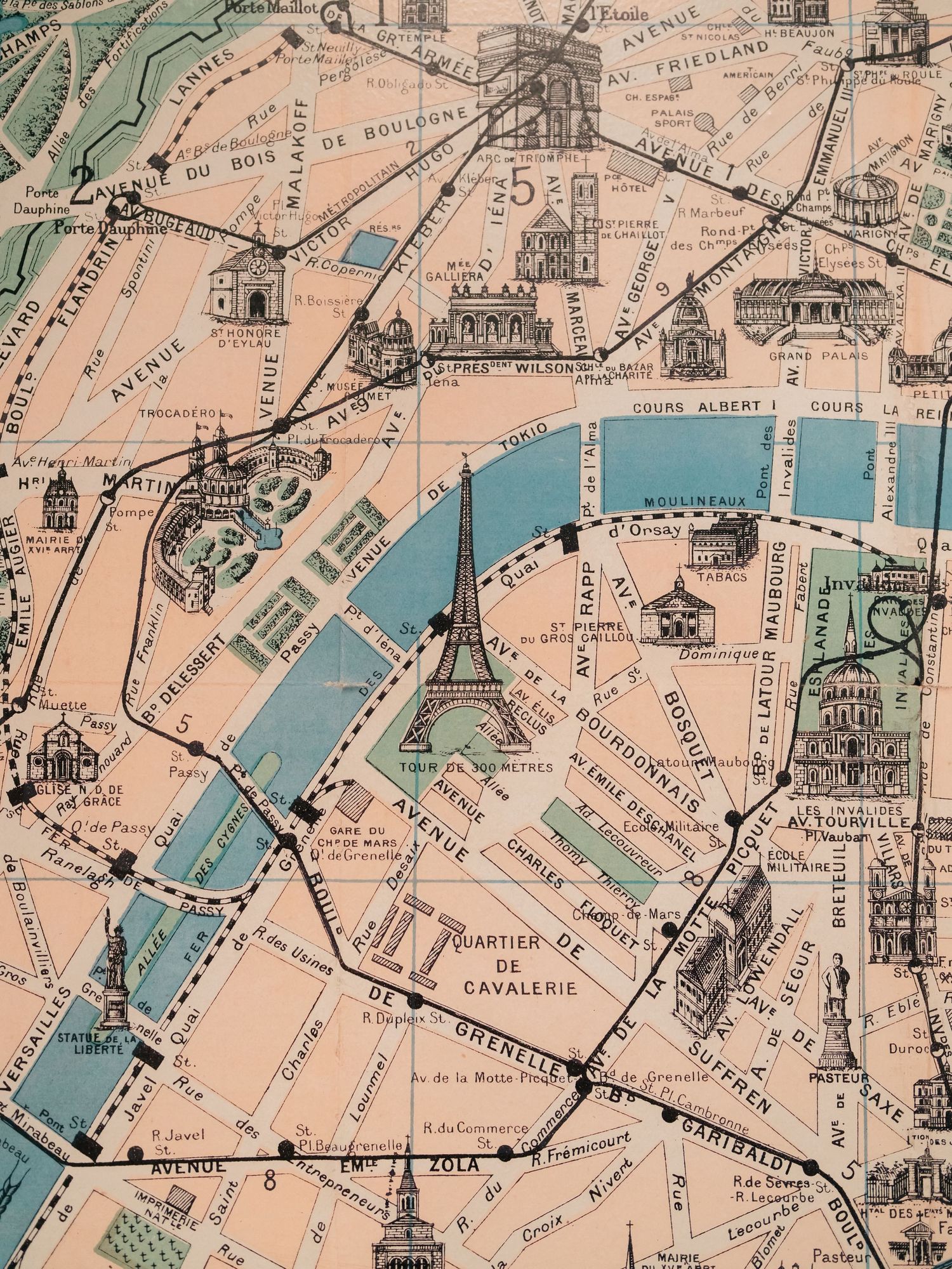 Vintage map section of Paris showing the Eiffel Tower, Seine River, and surrounding streets in muted pink and blue tones.