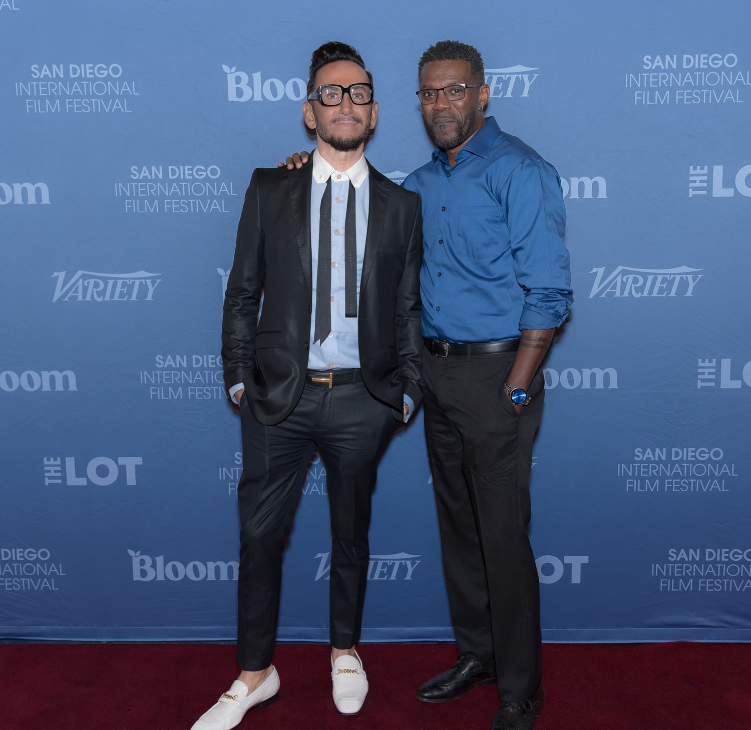 Two men pose on a red carpet at the San Diego International Film Festival, with Variety and Bloom logos visible.