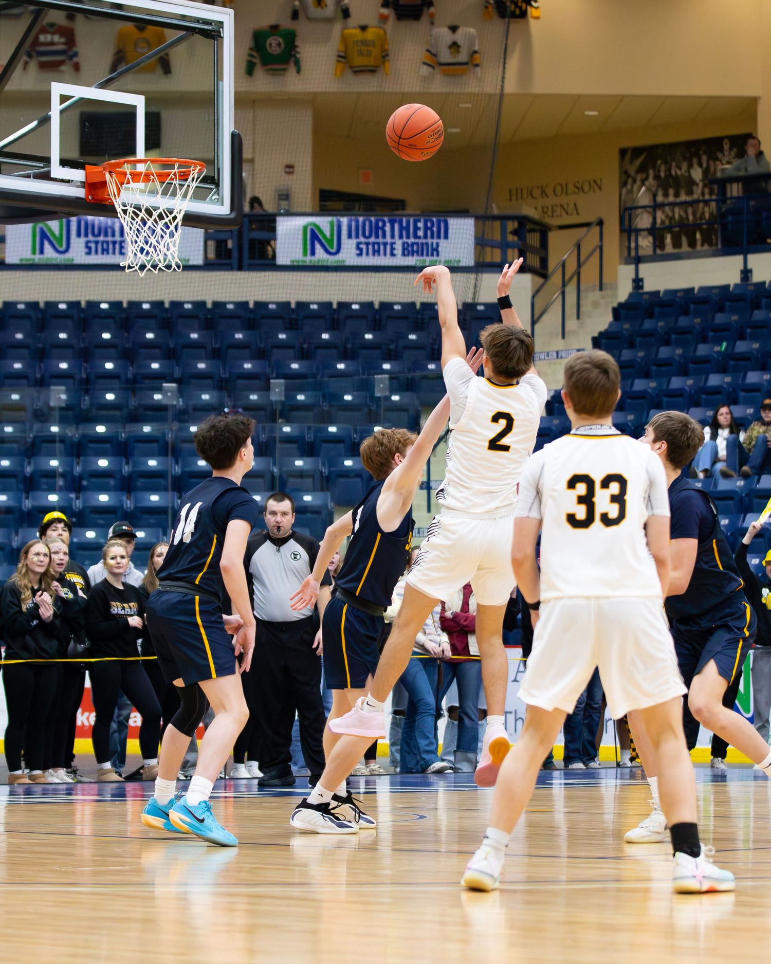 Player #2 in white jersey attempts layup during high school basketball game at Northern State Arena.