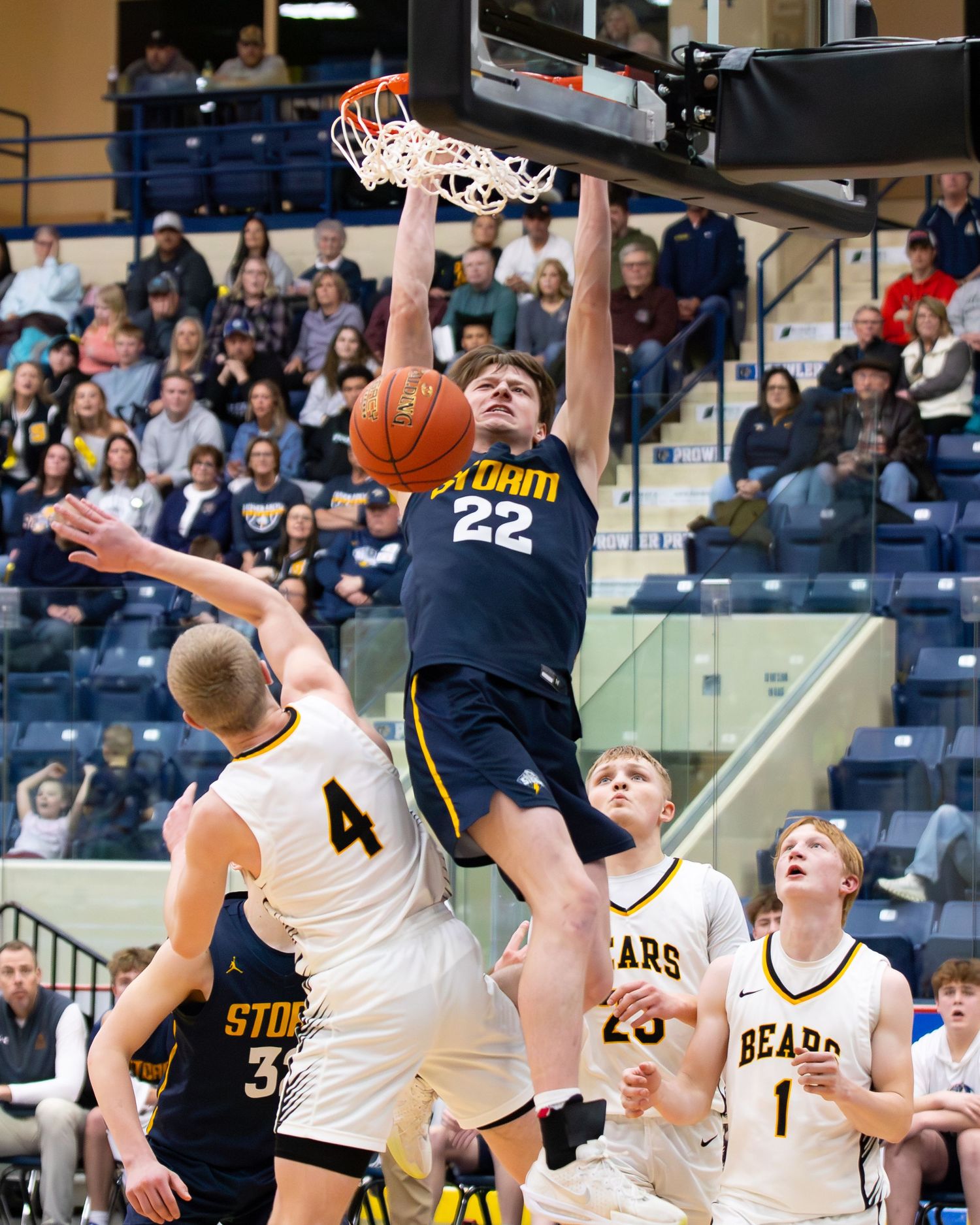 Basketball player number 22 in Storm jersey executes powerful slam dunk over defending Bears players.