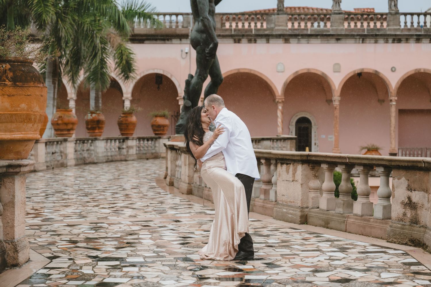 Couple sharing a romantic dip pose embrace on cobblestone courtyard of Ringling Museum, Sarasota Florida.