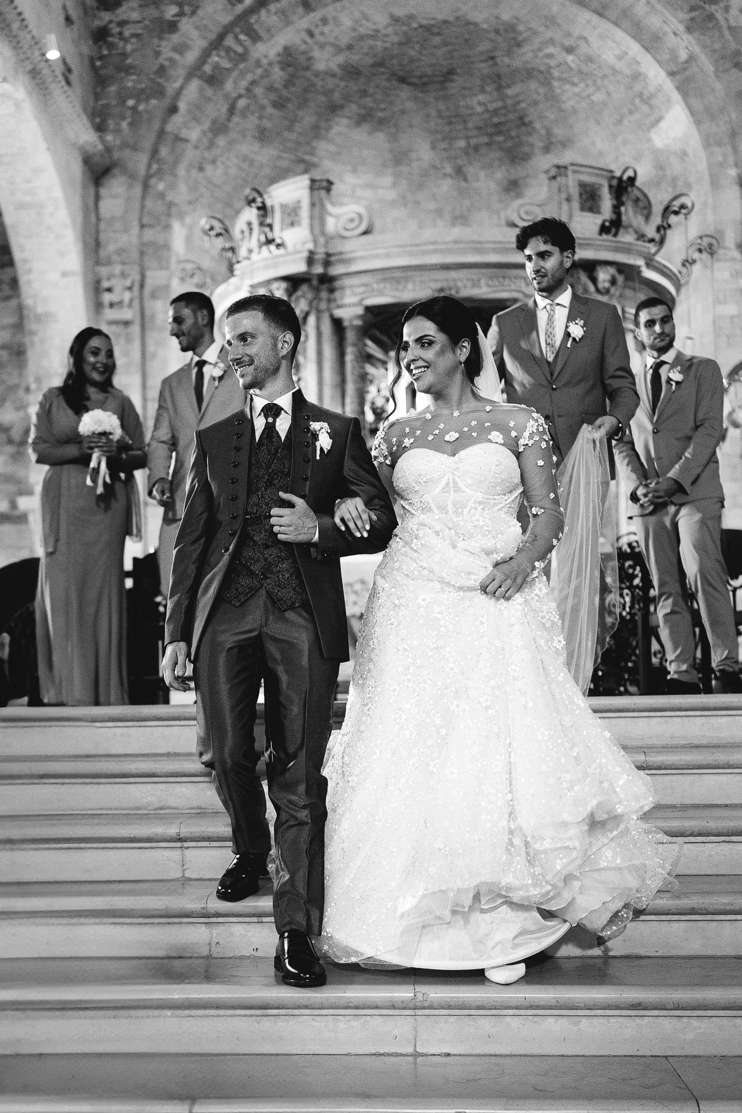 Bride and groom walking out of the church after their wedding ceremony in Italy