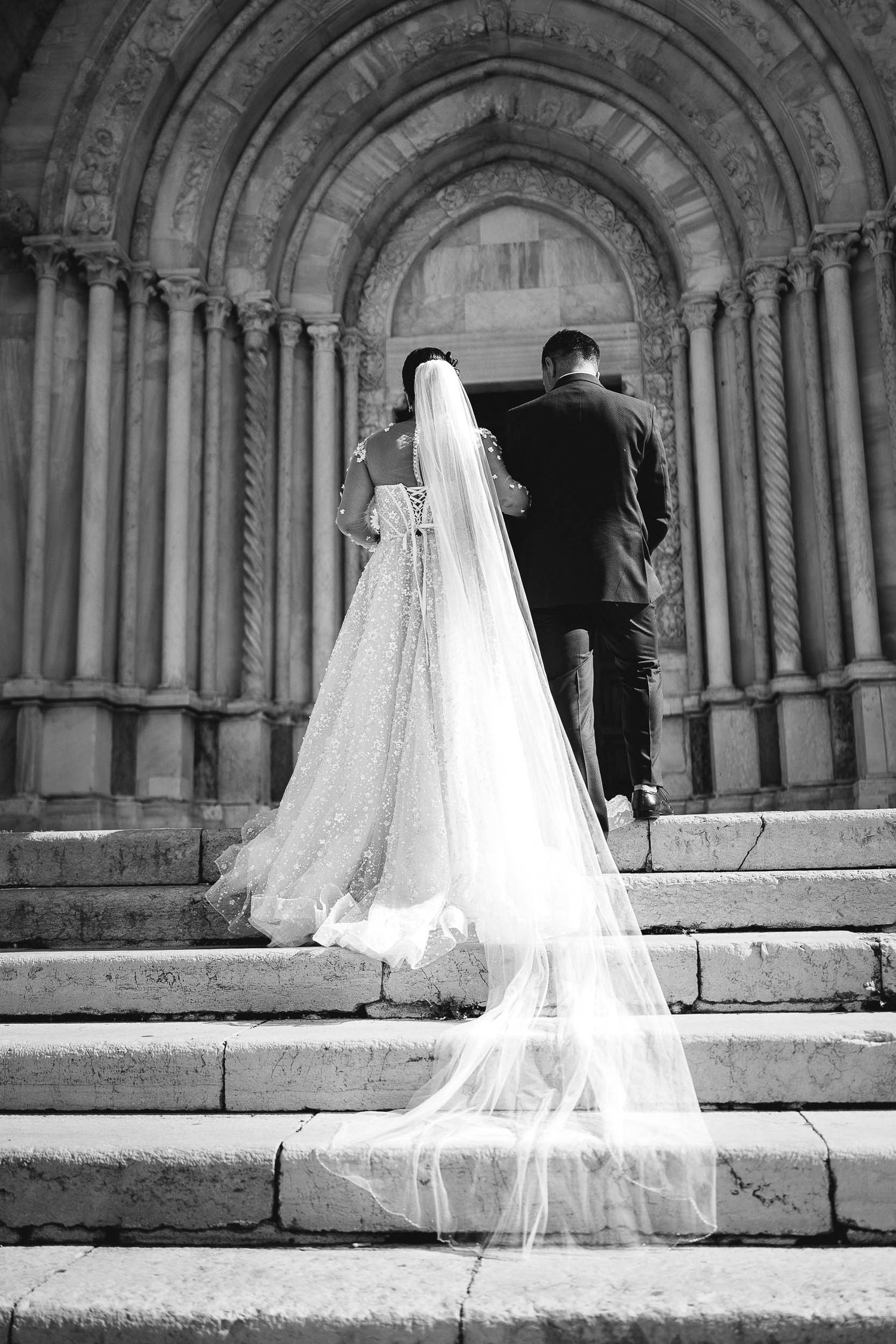 Bride walking with her father to the ceremony at an Italian church in the Marche region