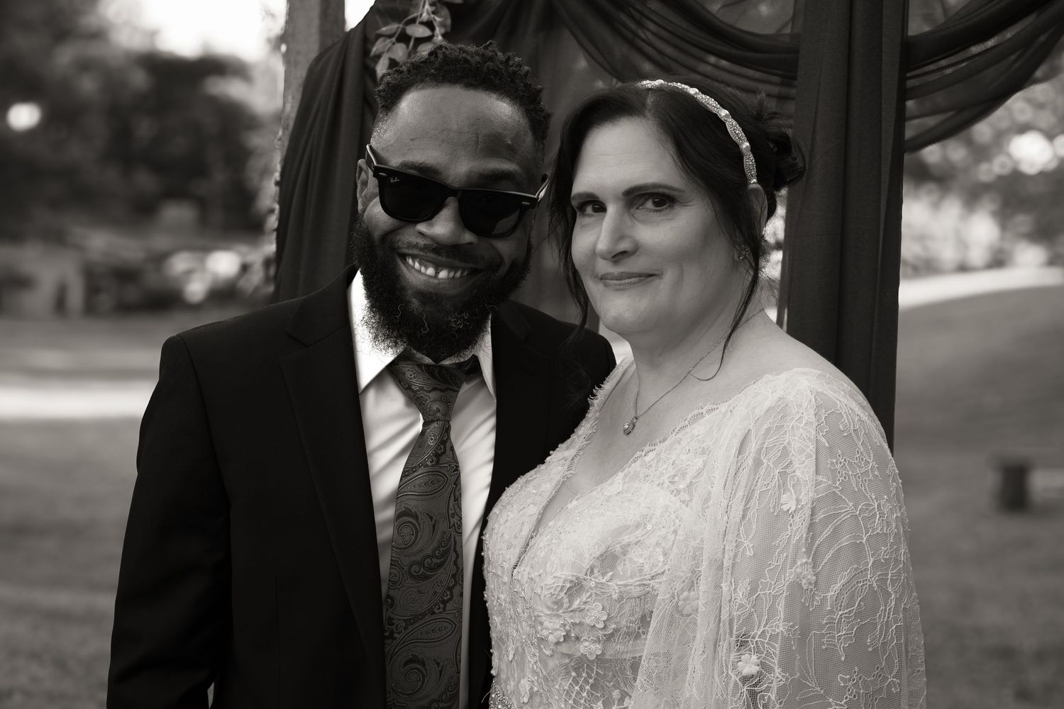 Black and white photo of a couple getting married in front of an alter.