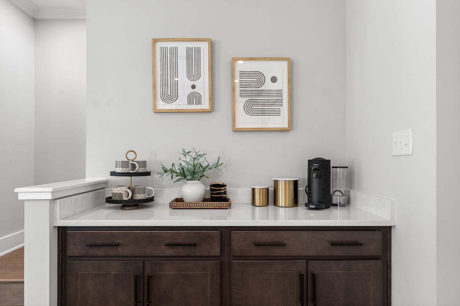 Modern living area featuring dark wood cabinets, white walls, and clean design aesthetic.
