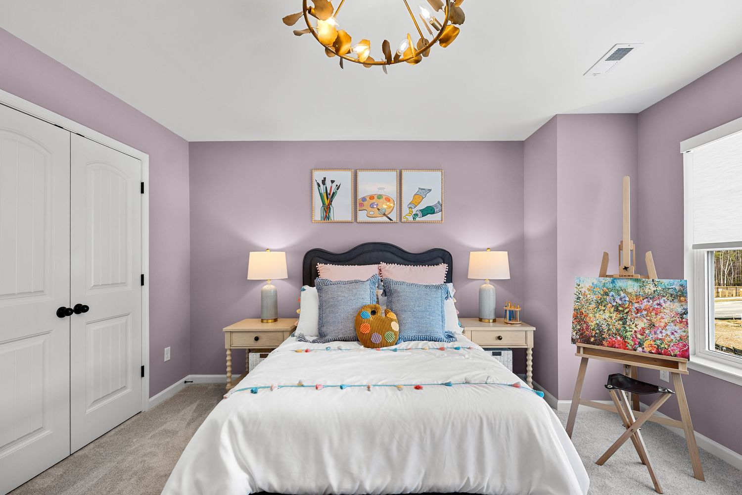 Modern bedroom with lavender walls, gold chandelier, and white bedding features contemporary decor and natural lighting.