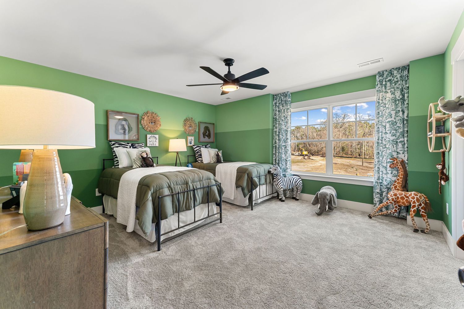 Spacious bedroom with bright green walls, metal bed frame, gray carpet, and large windows with patterned curtains.