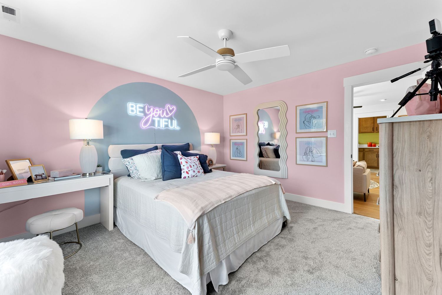 A modern pink and gray bedroom design features minimalist decor, geometric patterns, and clean lines throughout the space.