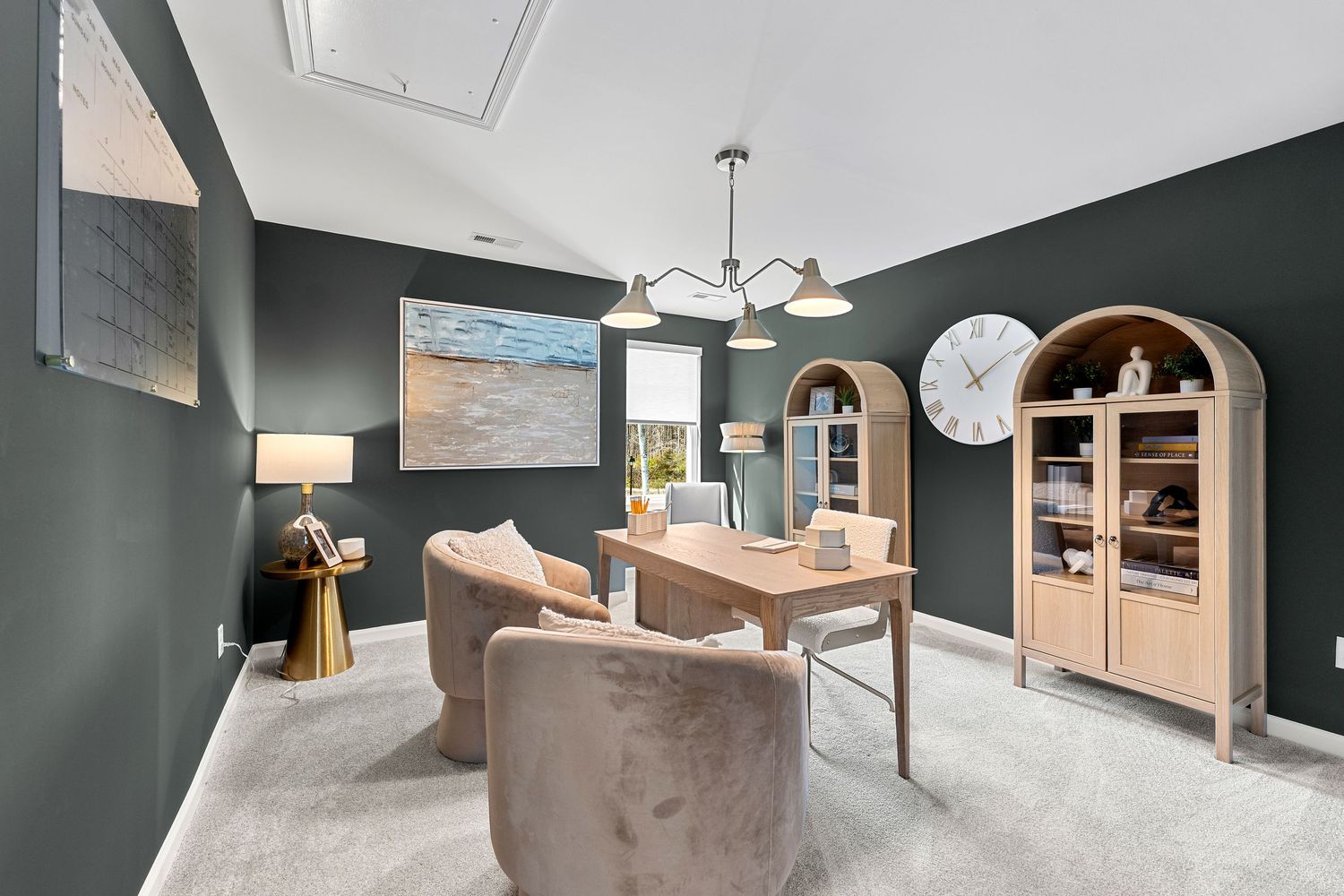 Modern interior with dark teal walls, contemporary lighting, and built-in storage solutions.