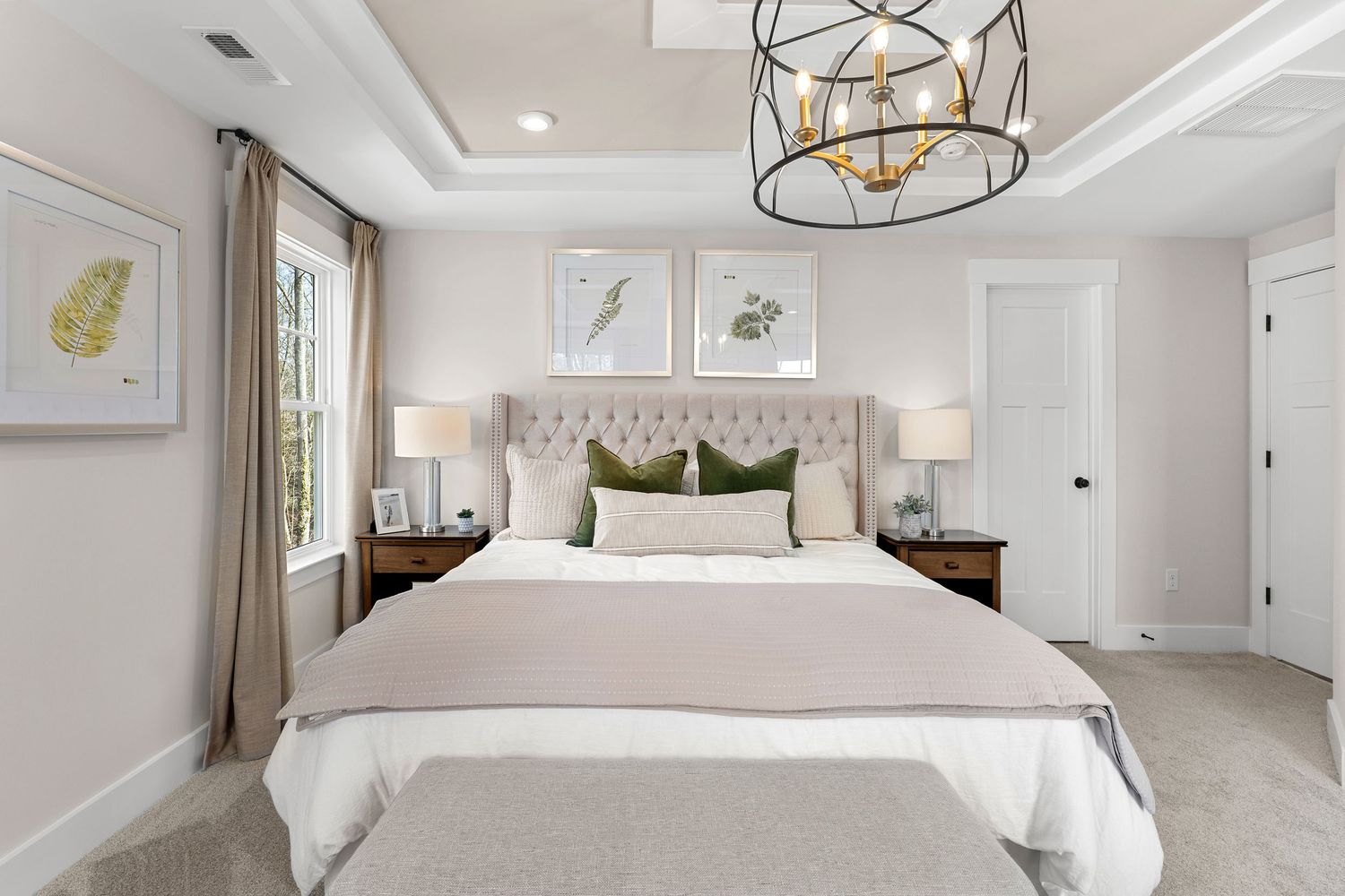 Serene master bedroom with tufted headboard, drum chandelier, and neutral color palette.