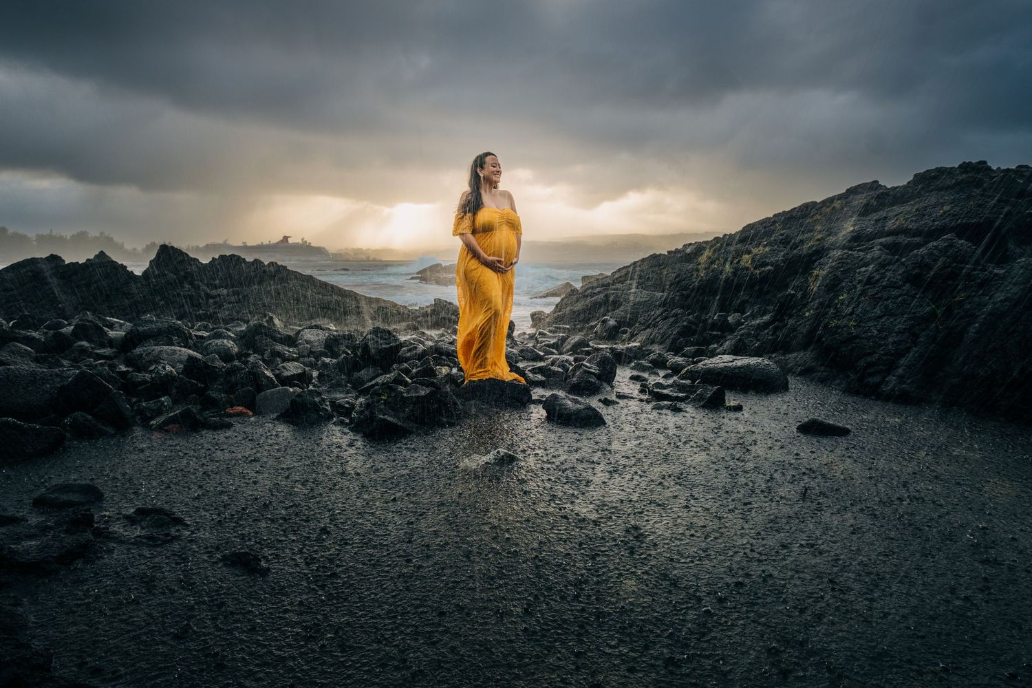 Dramatic silhouette portrait against moody sky on volcanic rocks in Hilo, Big Island of Hawaii.