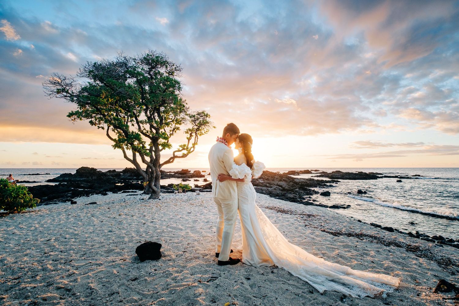 Dreamy beach wedding photography with pastel sunset sky and palm trees at Kikaua Point Beach, Big Island of Hawaii.