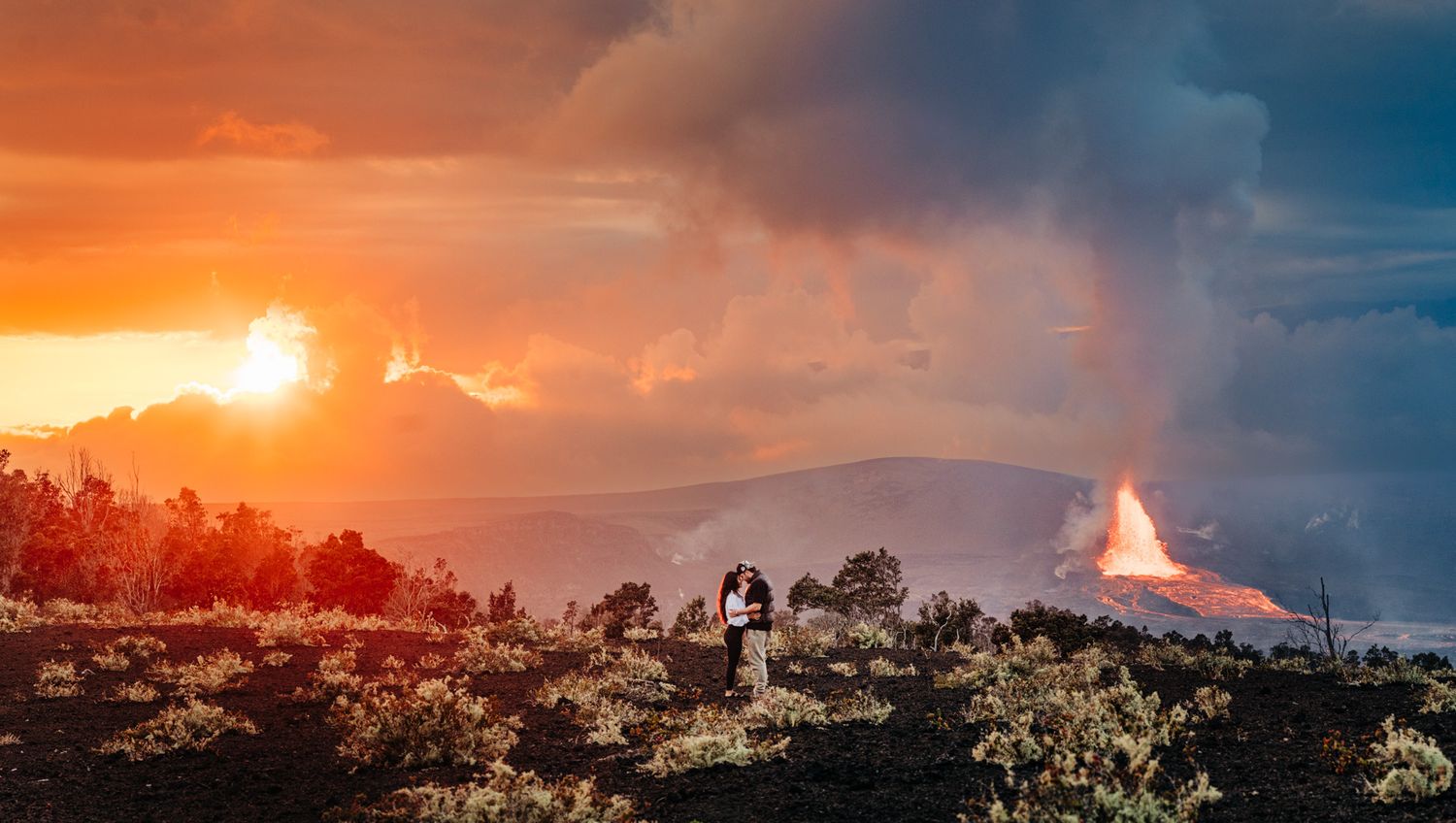 Dramatic orange and purple sunset sky over a mountain landscape at Volcano National Park, Big Island of Hawaii.