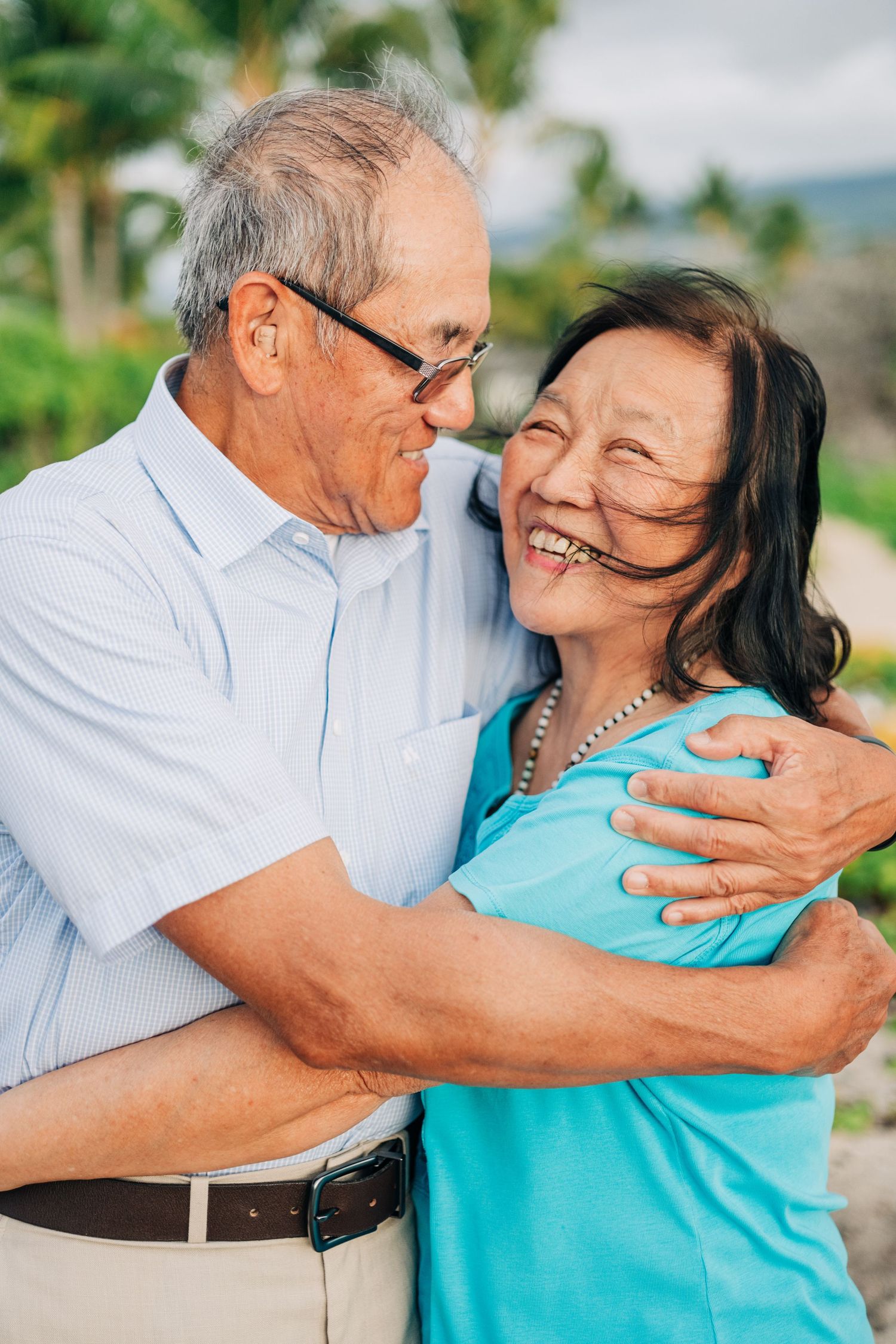 Couple sharing affectionate moments outdoors in casual attire. Kona Family Photography, Big Island of Hawaii.