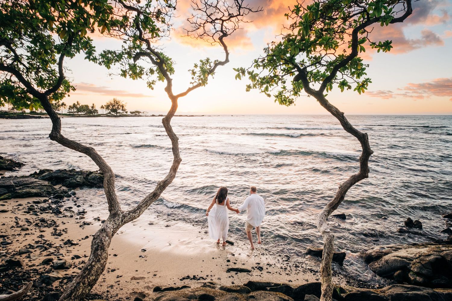 Beautiful beach wedding ceremony setup with curved benches at sunset on Kukio Beach, Kona, Big Island Hawaii.