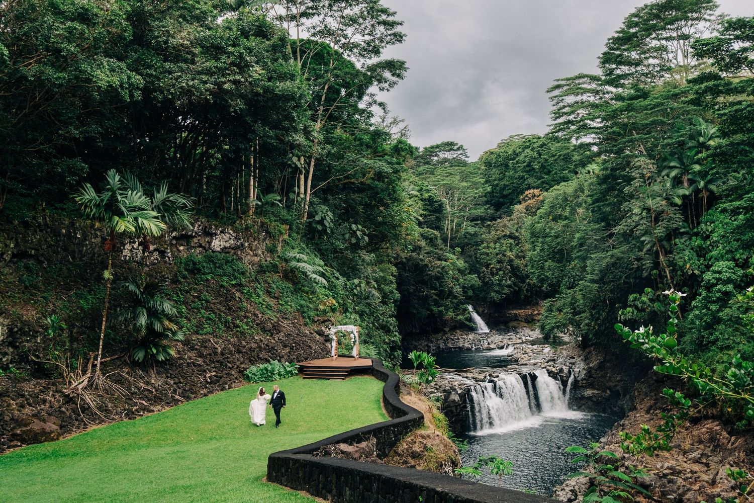 Lush tropical Hawaiian landscape with waterfall and green vegetation at the Falls at Reeds Island, Hilo, Hawaii.