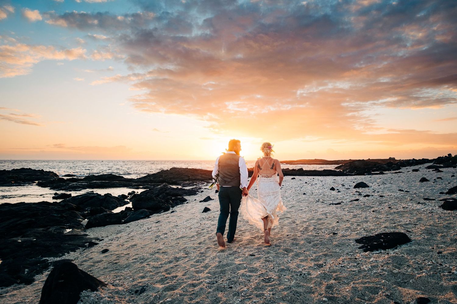 Golden hour beach photography with silhouettes against dramatic sunset sky at Kona Sea Salt, Big Island Hawaii.