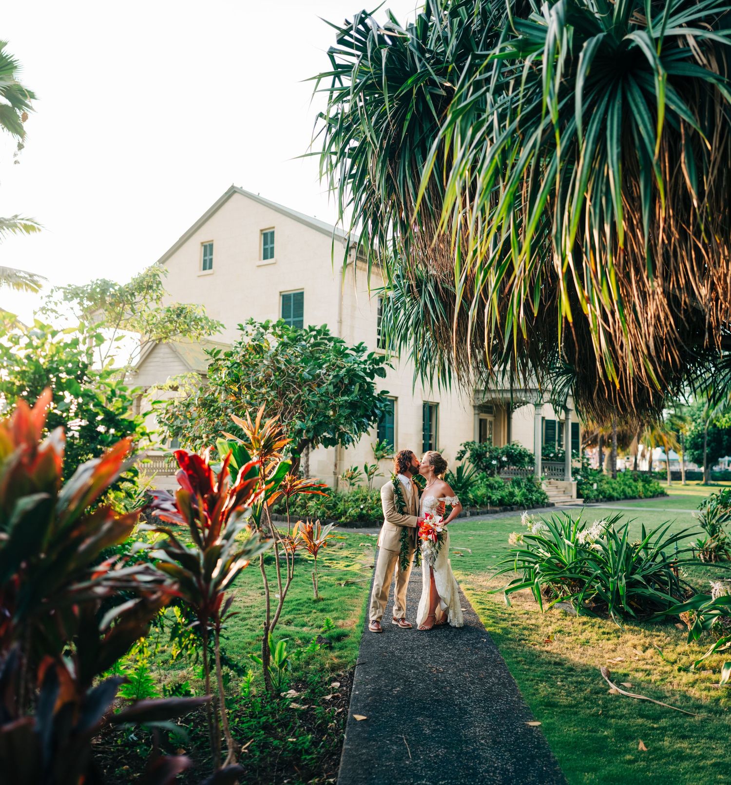Historic Hulihee Palace wedding surrounded by palm trees and foliage in Kona, Big Island of Hawaii.